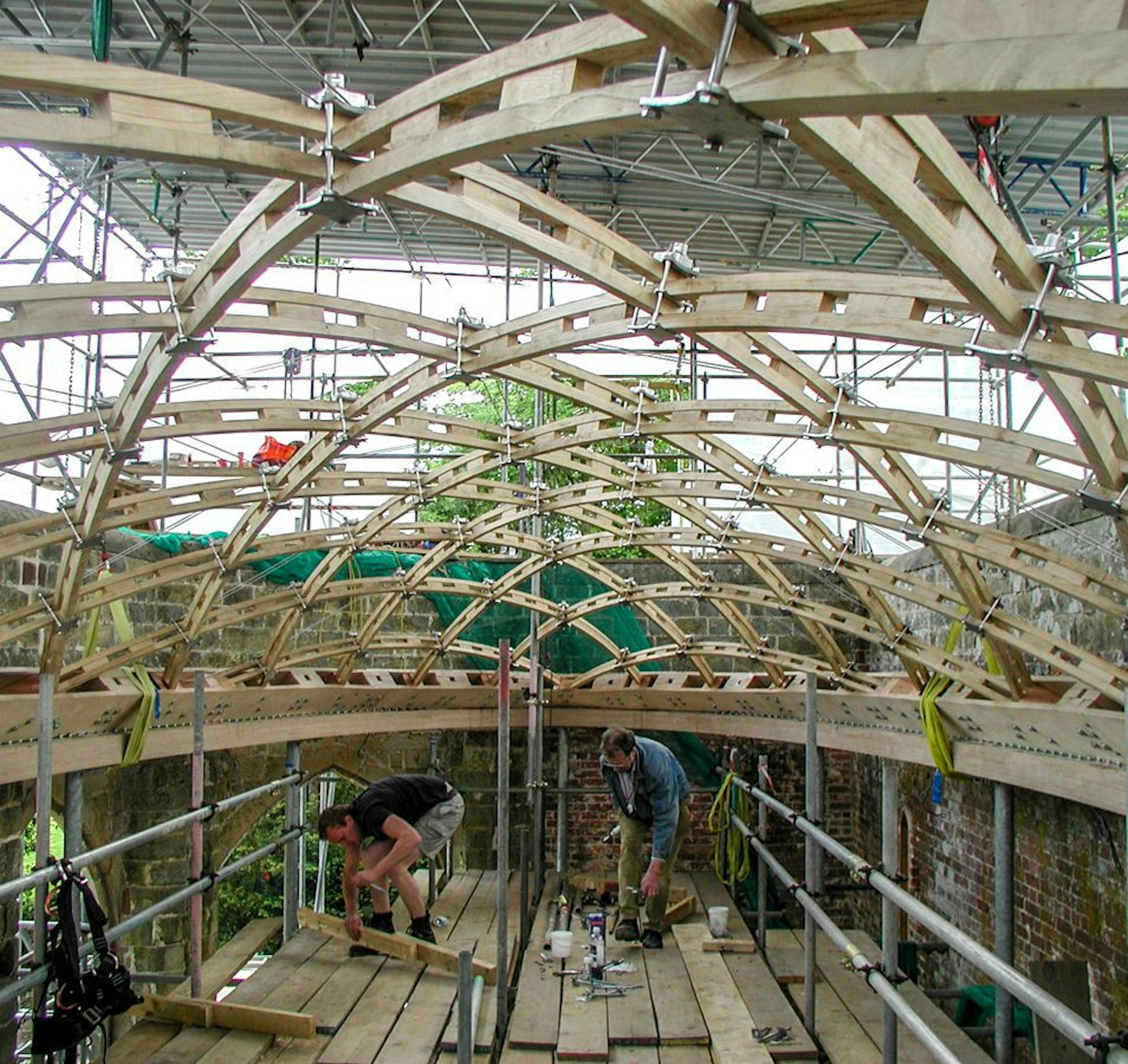 The complex installation of a glazed timber frame gridshell roof