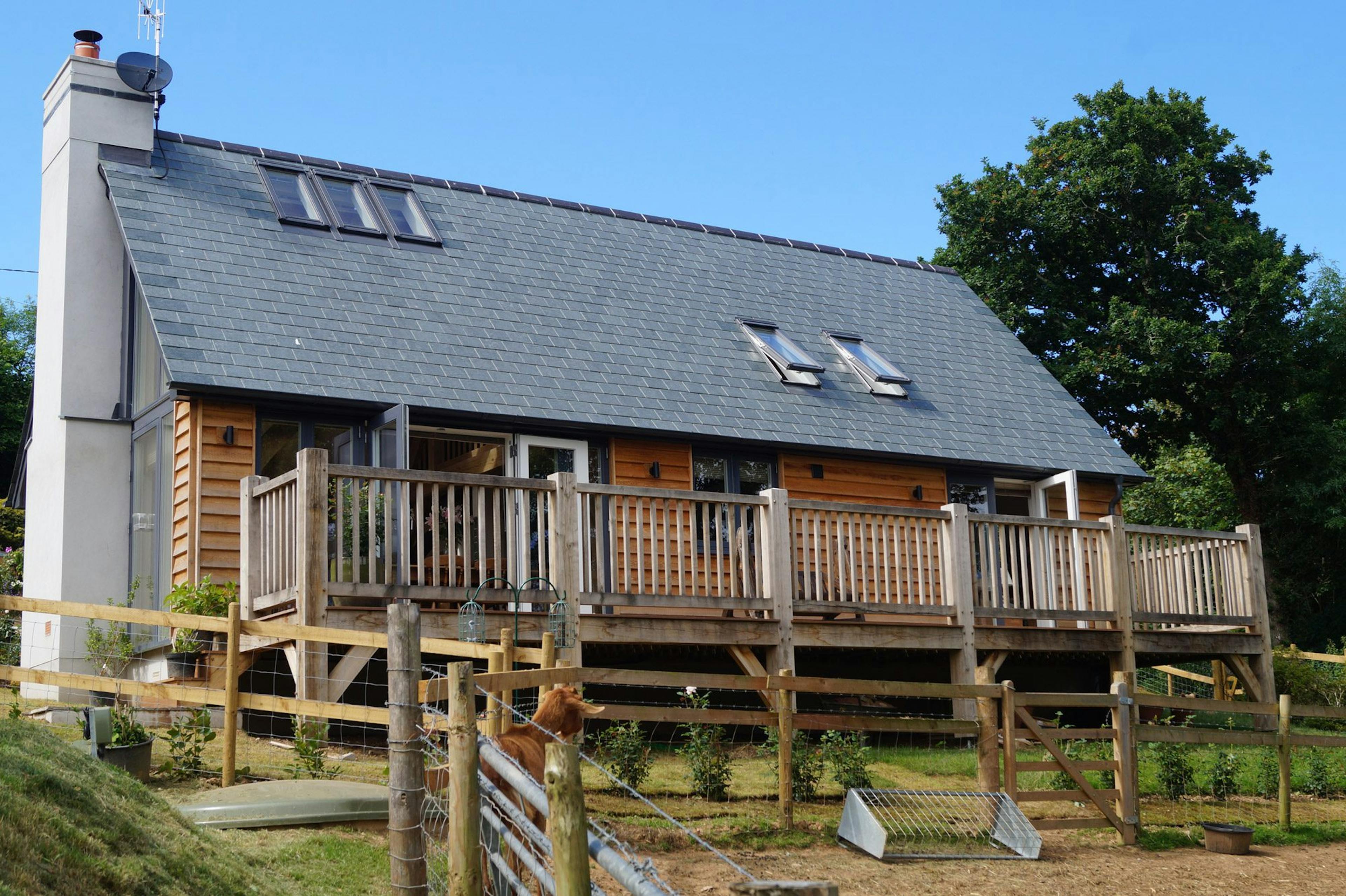 Oak-framed family home exterior featuring a wrap-around balcony