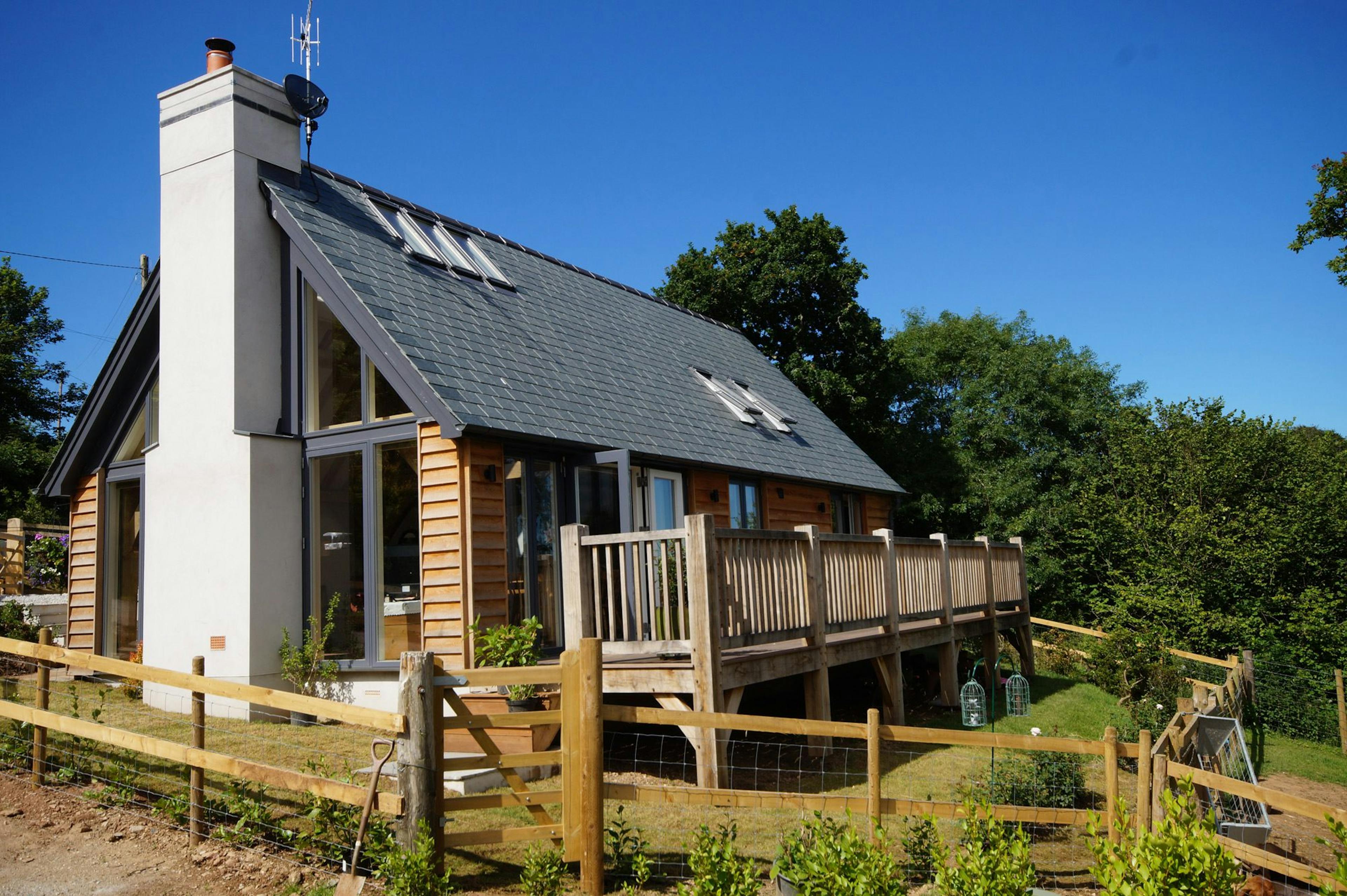 Oak-framed family home exterior showcasing glazing, balcony, and gable features
