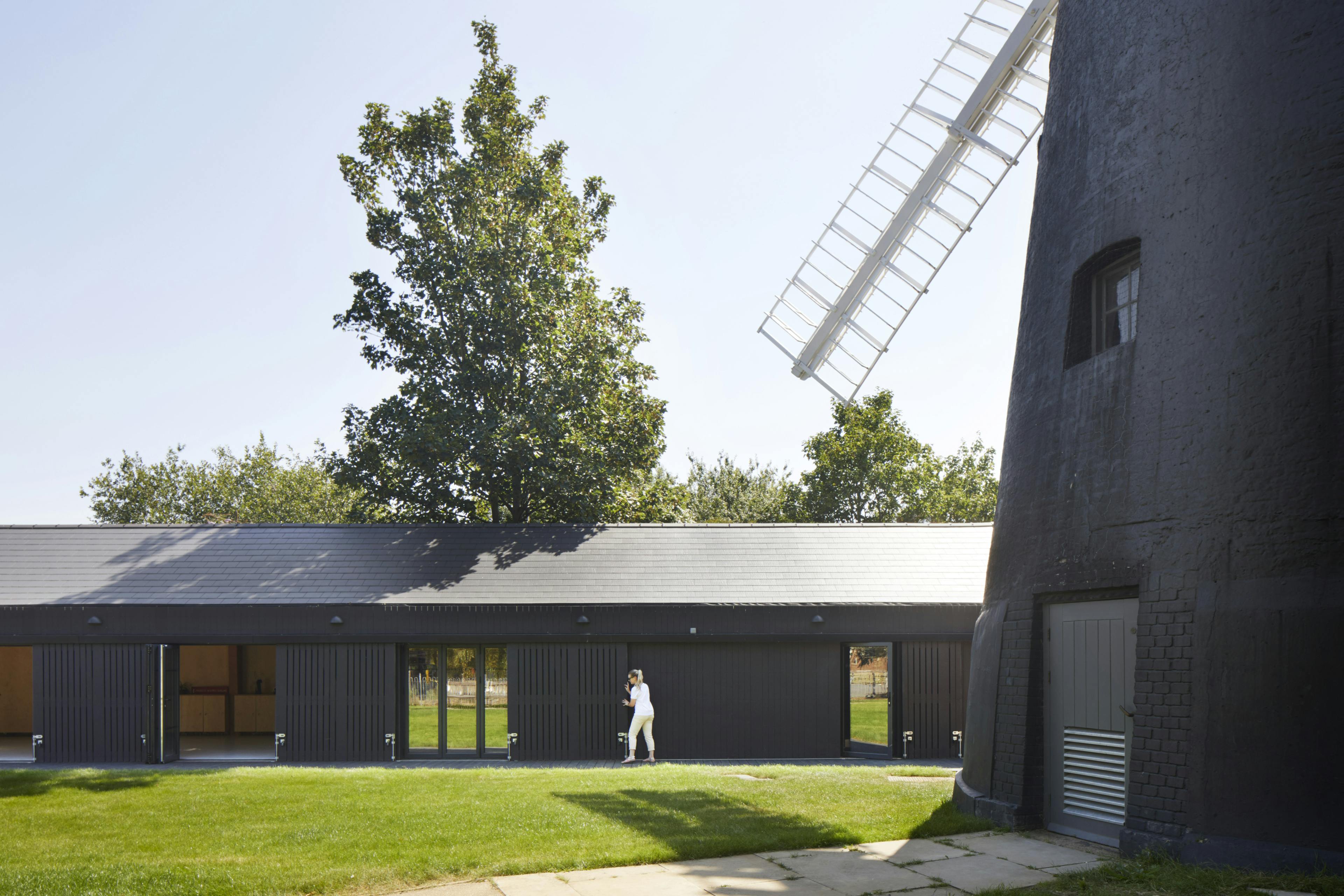 A black clad windmill and black clad timber framed community centre