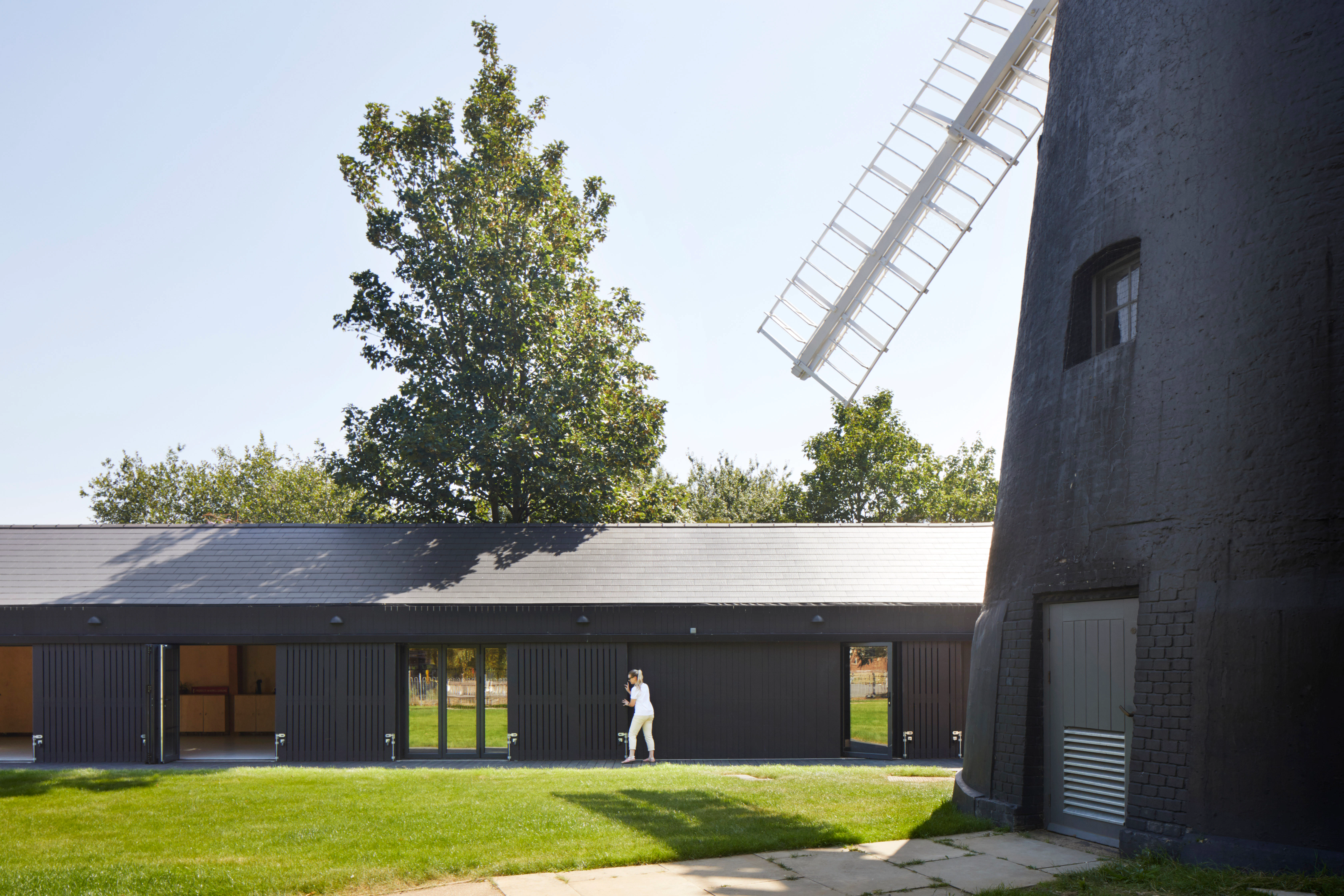 A black clad windmill and black clad timber framed community centre