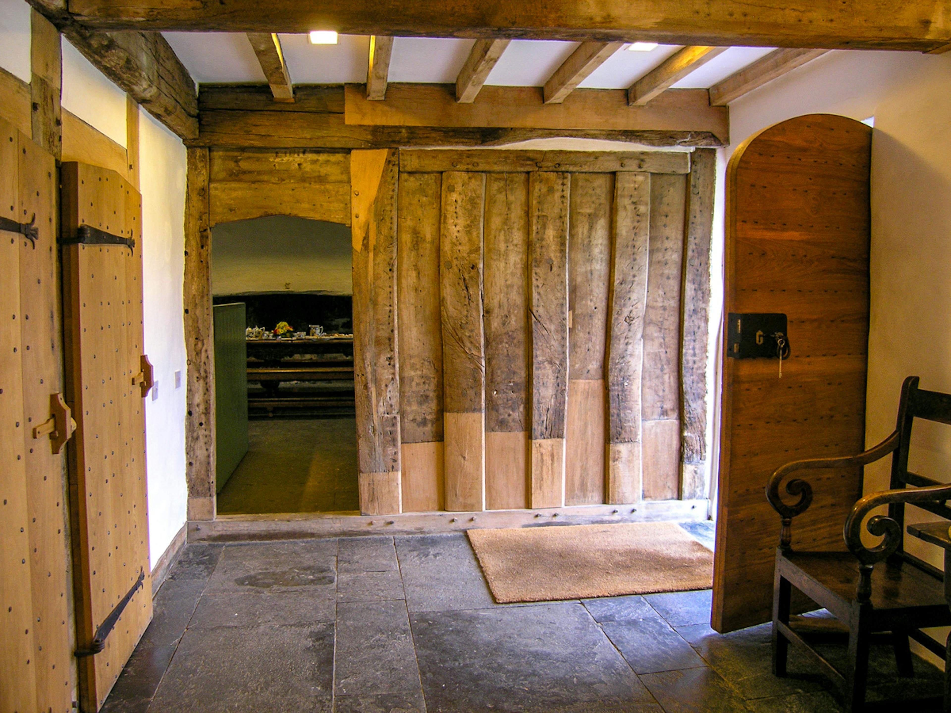 The entrance in a restored 16th century barn with wood panelling