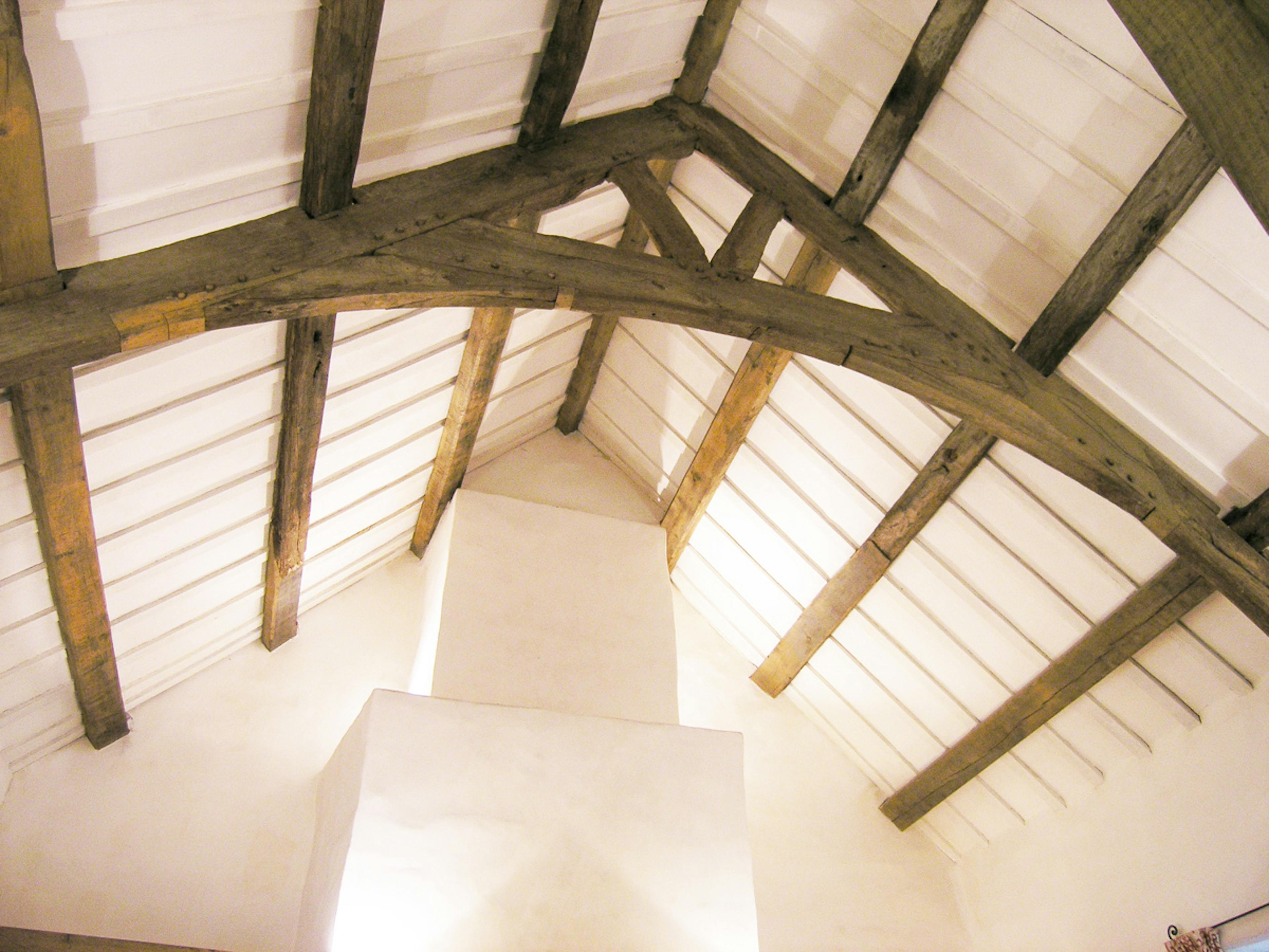 The oak roof truss in a restored 16th century barn house