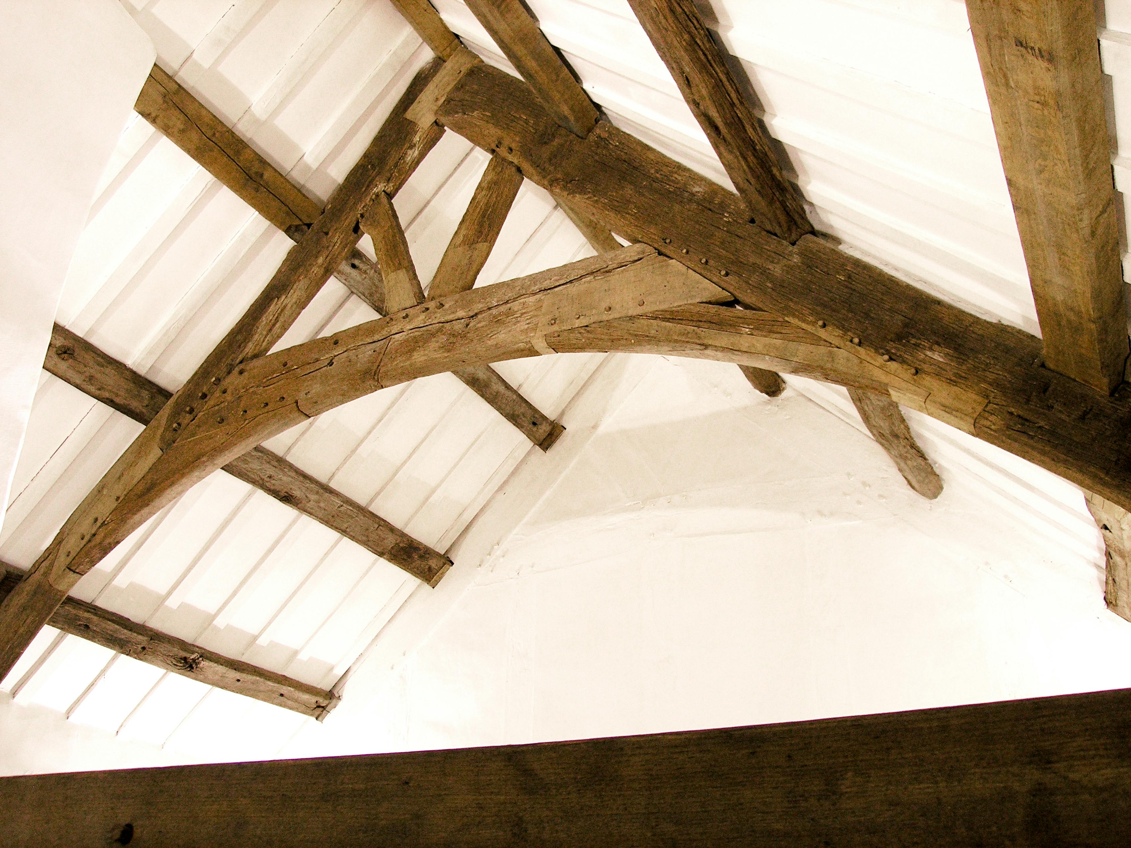 The oak roof truss in a restored 16th century barn house