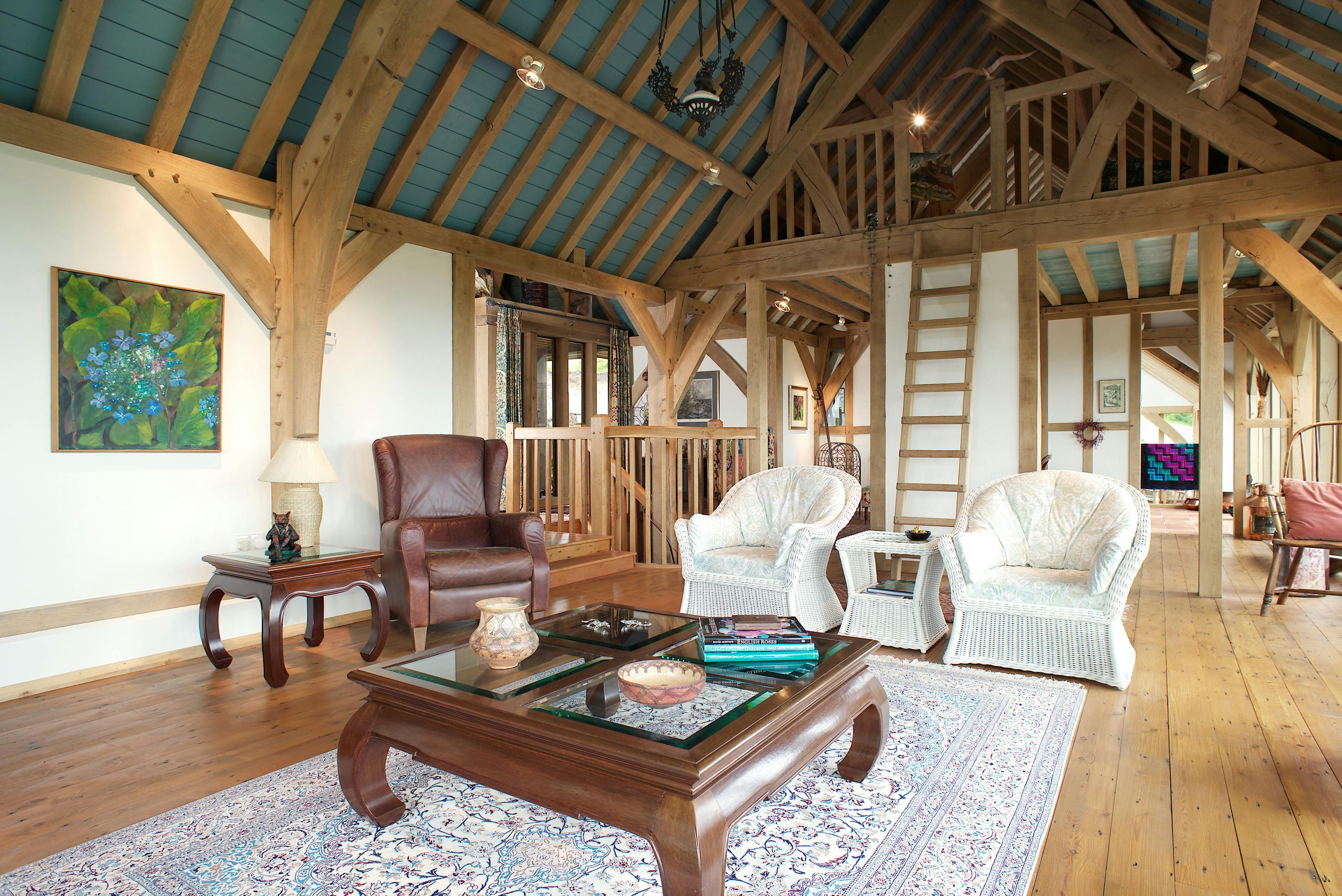The large sitting room with a mezzanine of an oak frame home