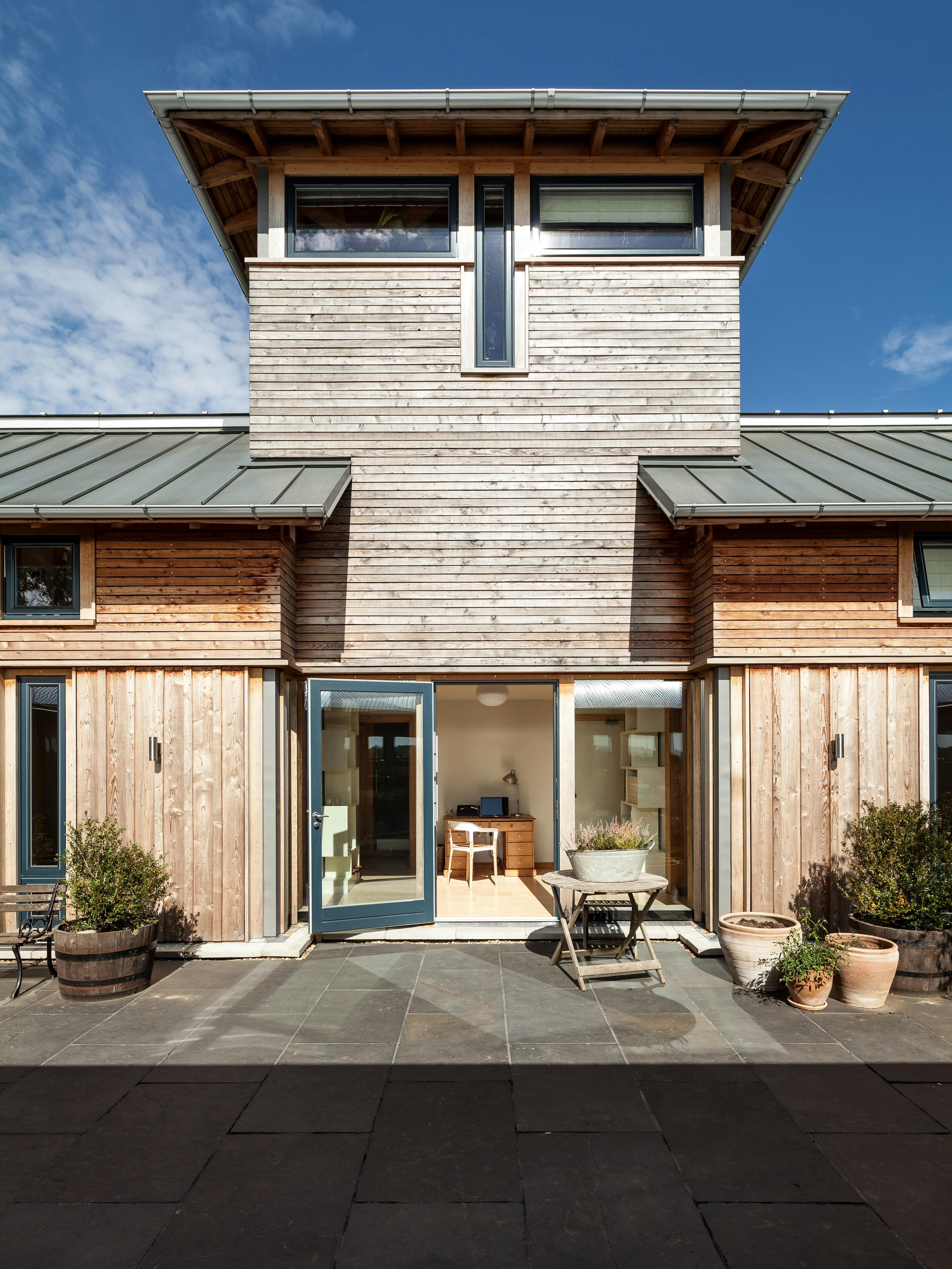 The tower of a timber clad large family farmhouse