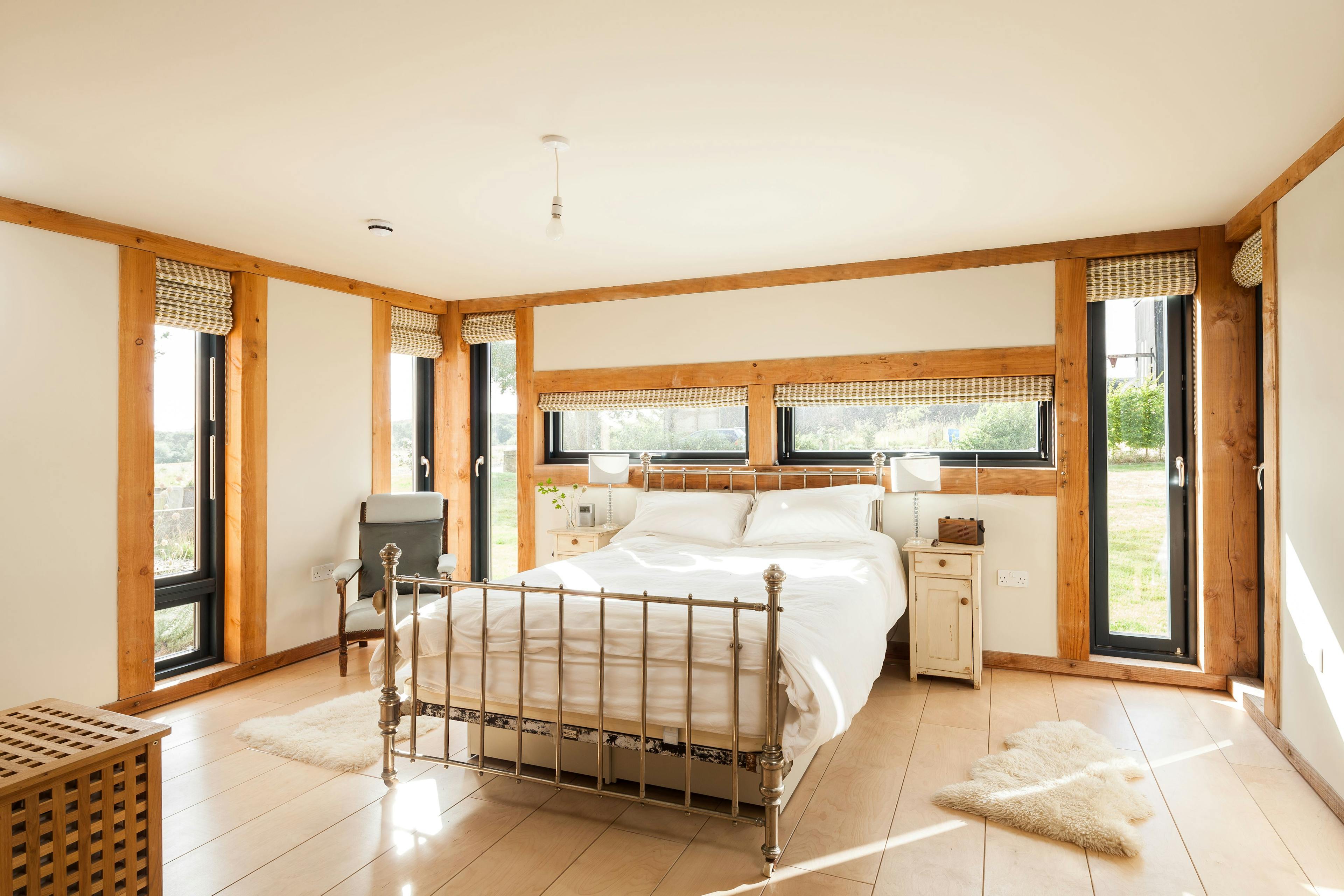 A bedroom in a Douglas fir framed family farmhouse