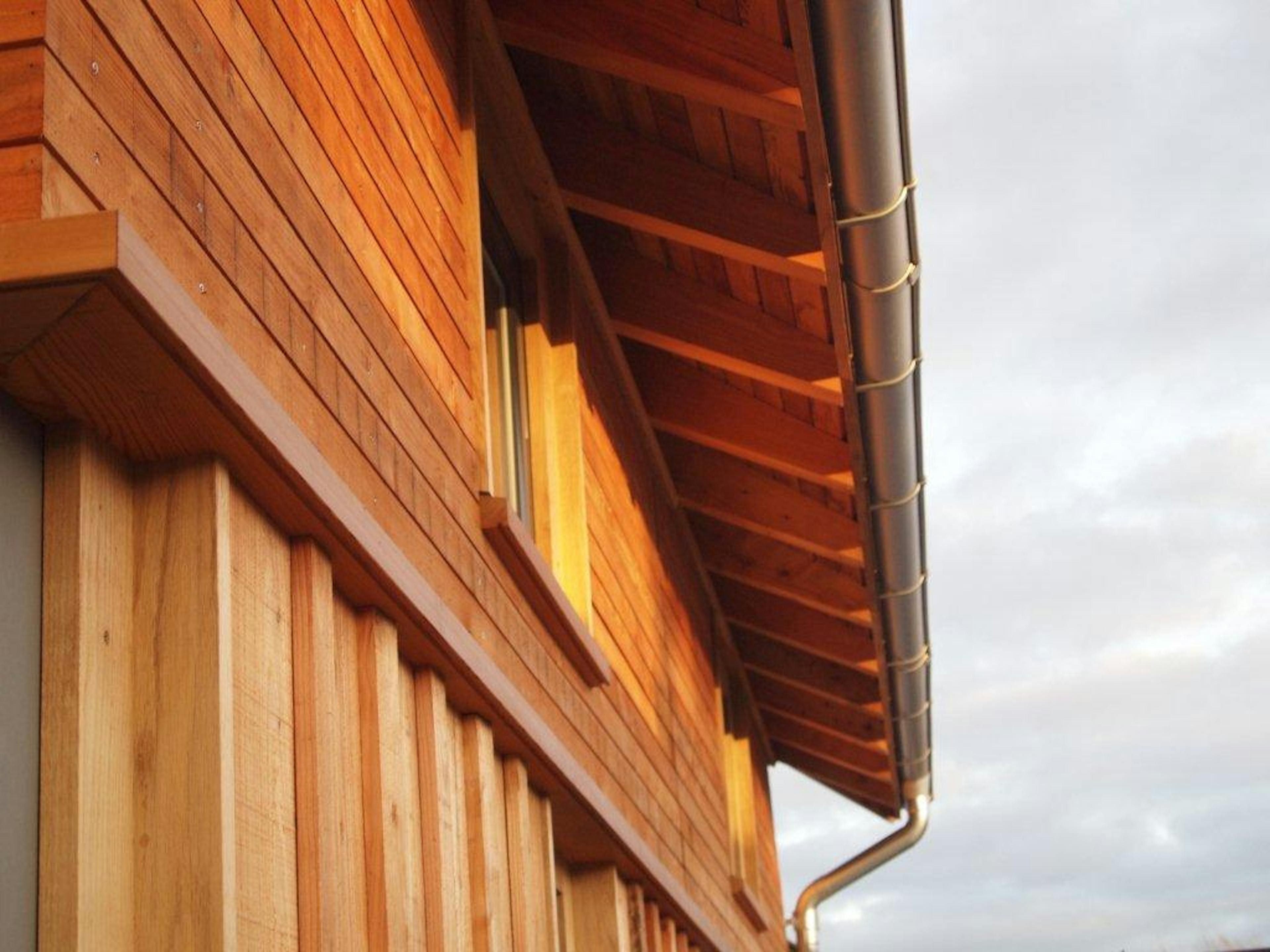 A close up of a timber clad large family farmhouse
