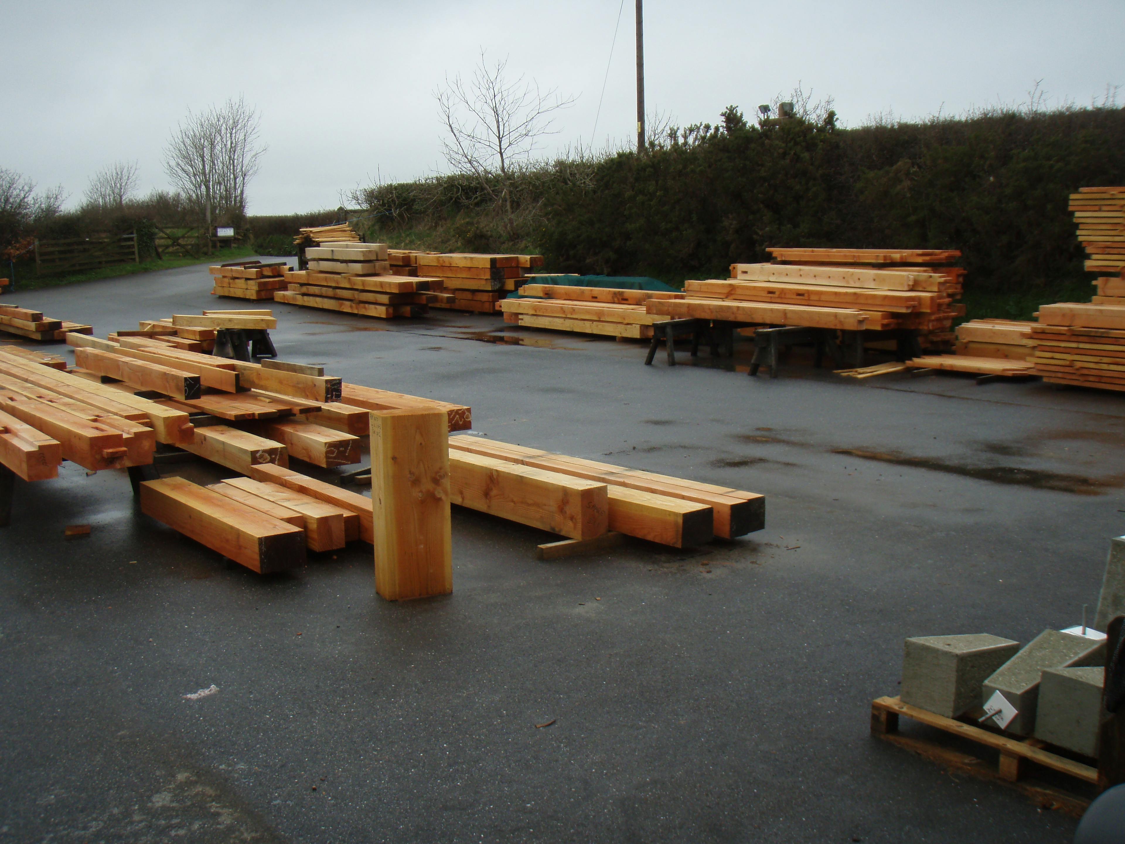 The timber for a Douglas fir framed large family farmhouse stacked in a framing yard