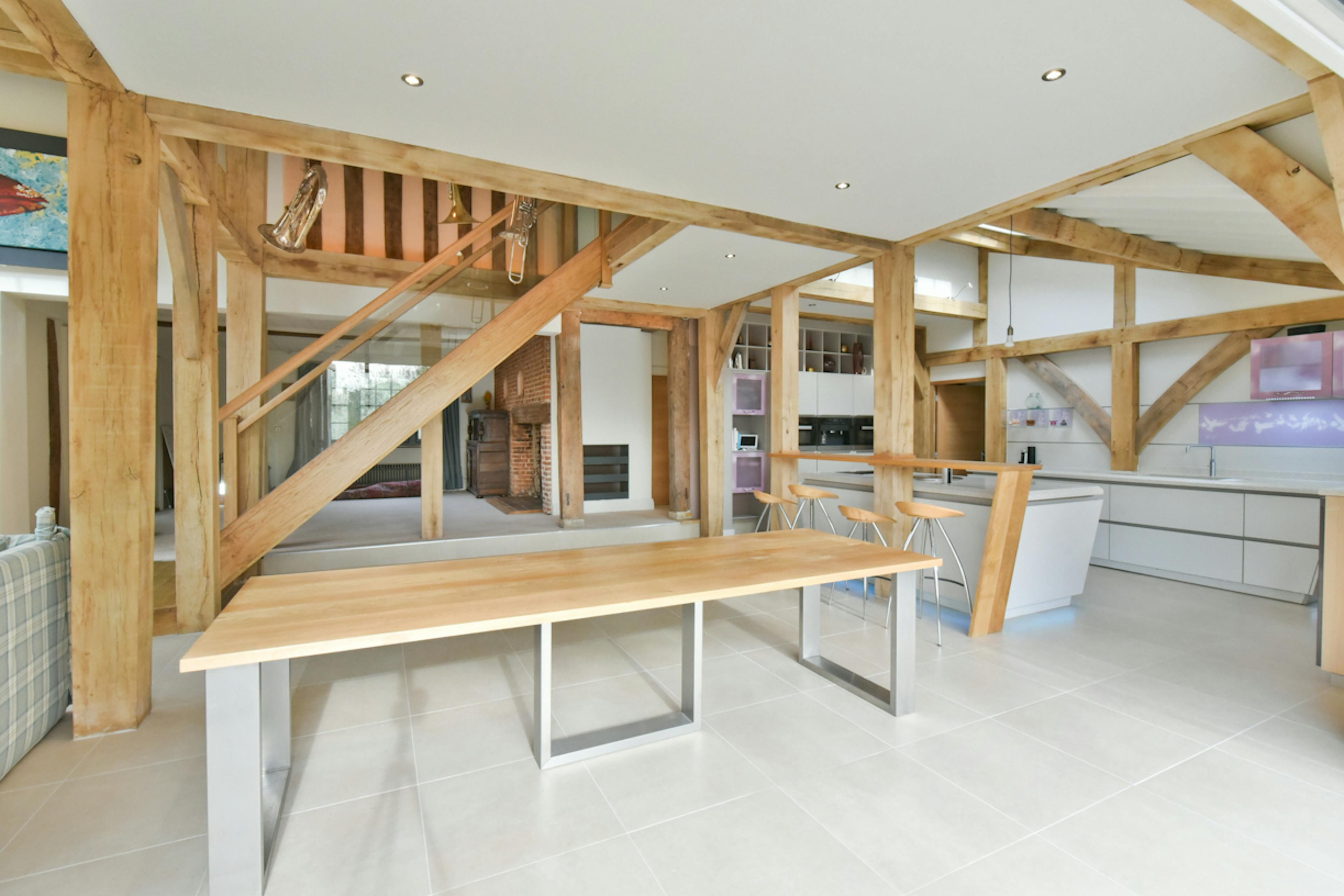 An open plan kitchen and dining area in an oak framed extension to a 17th century pub