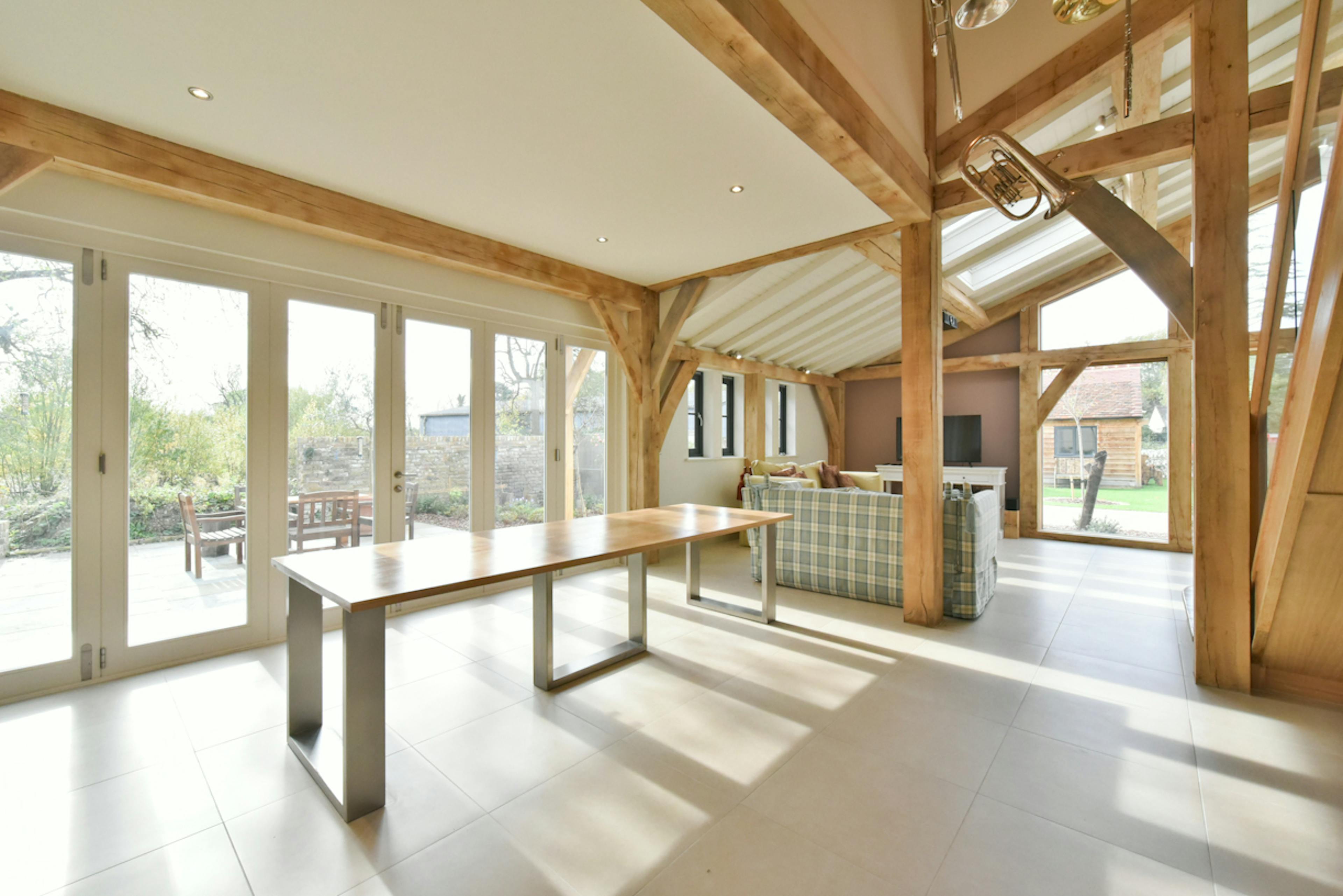 An open plan dining and sitting area in an oak framed extension to a 17th century pub