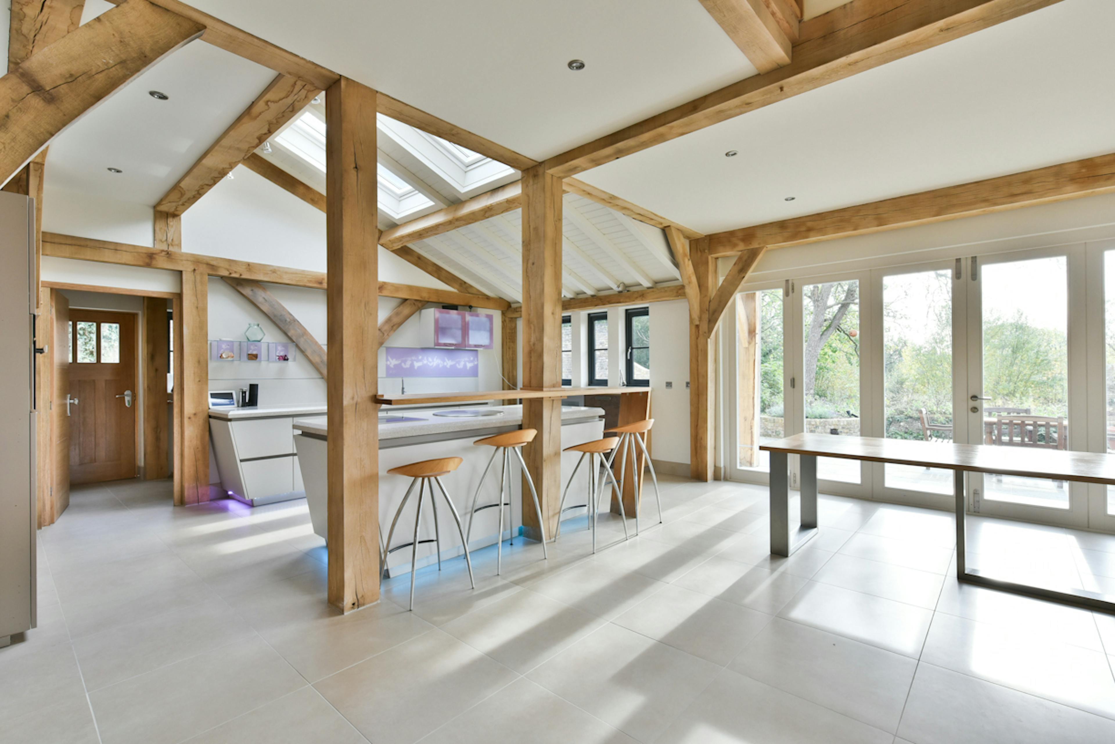 An open plan kitchen and dining area in an oak framed extension to a 17th century pub