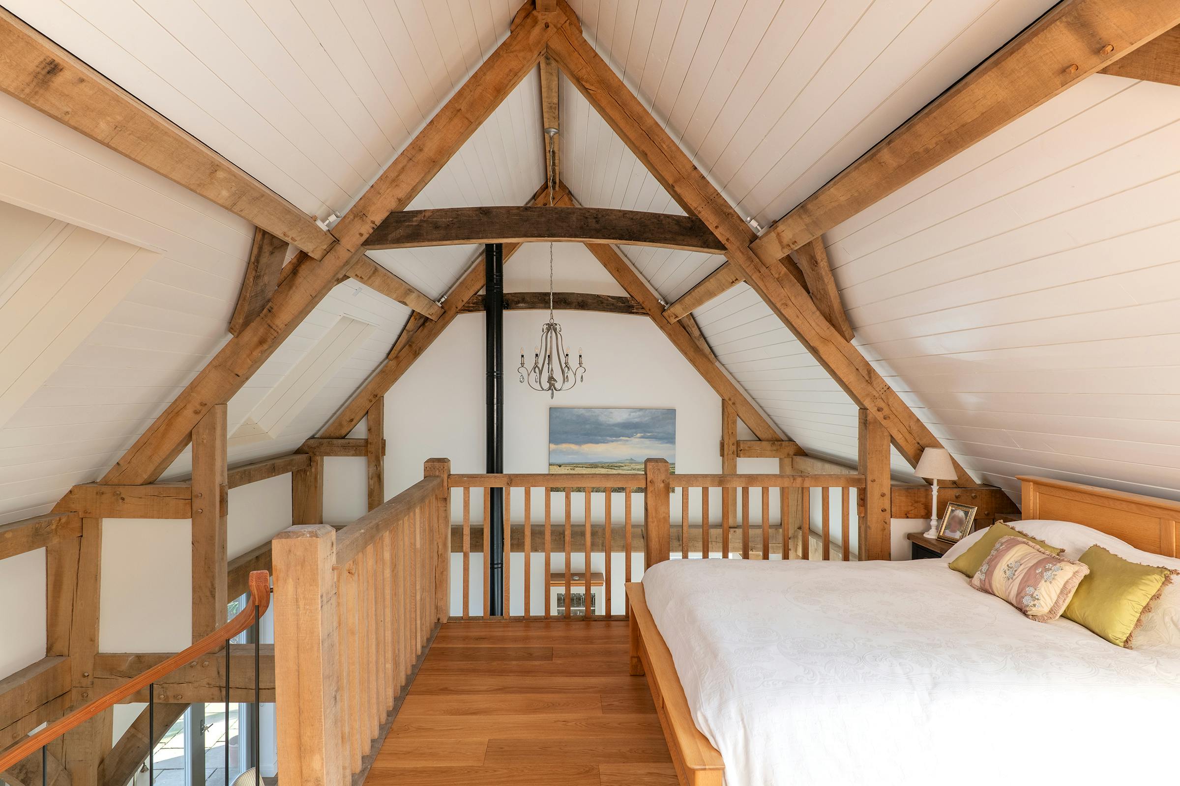 A mezzanine bedroom in an oak frame home