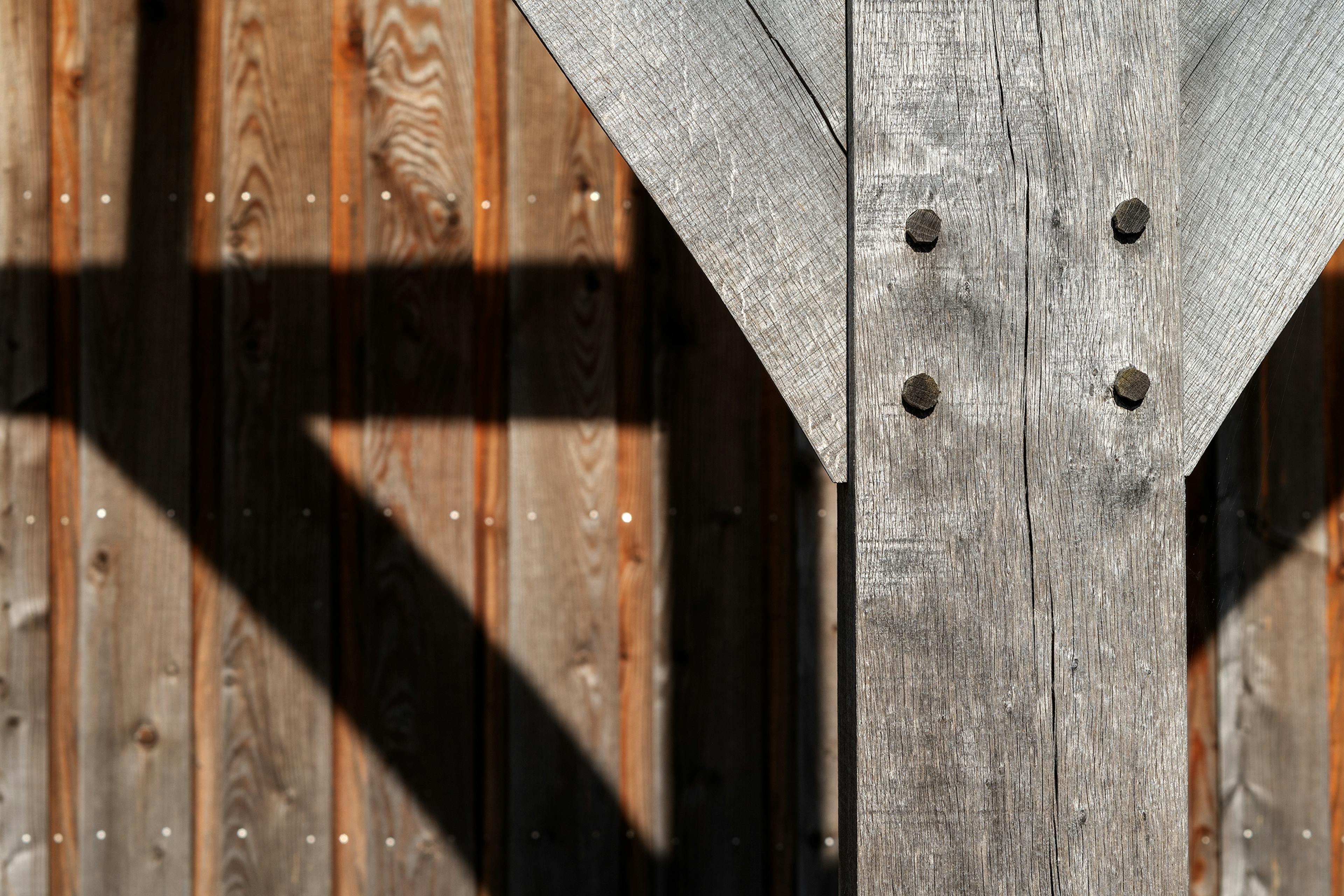 A silvered oak post with wooden pegs on an oak framed veranda