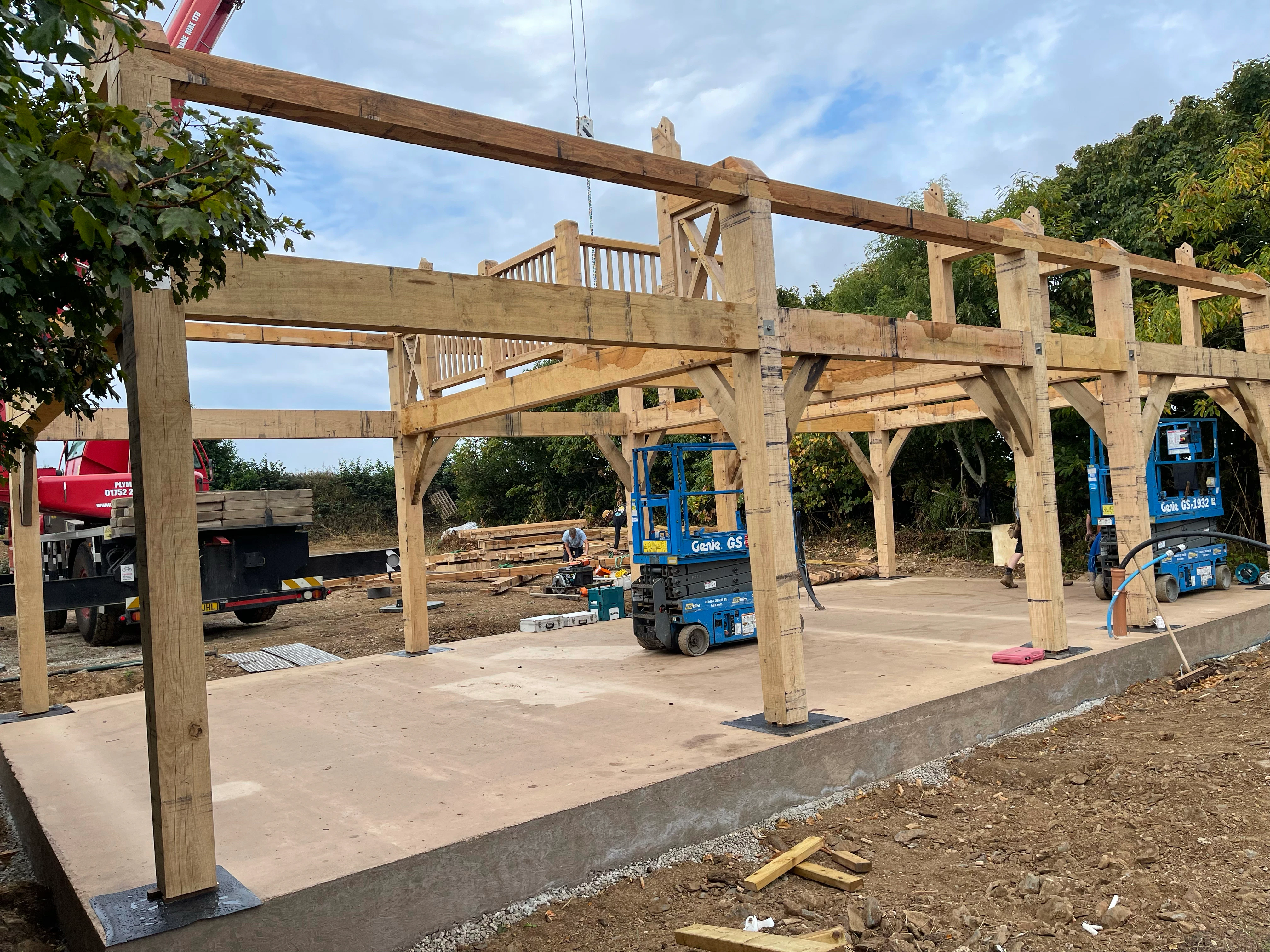 An oak frame for a home being installed with genie lifts