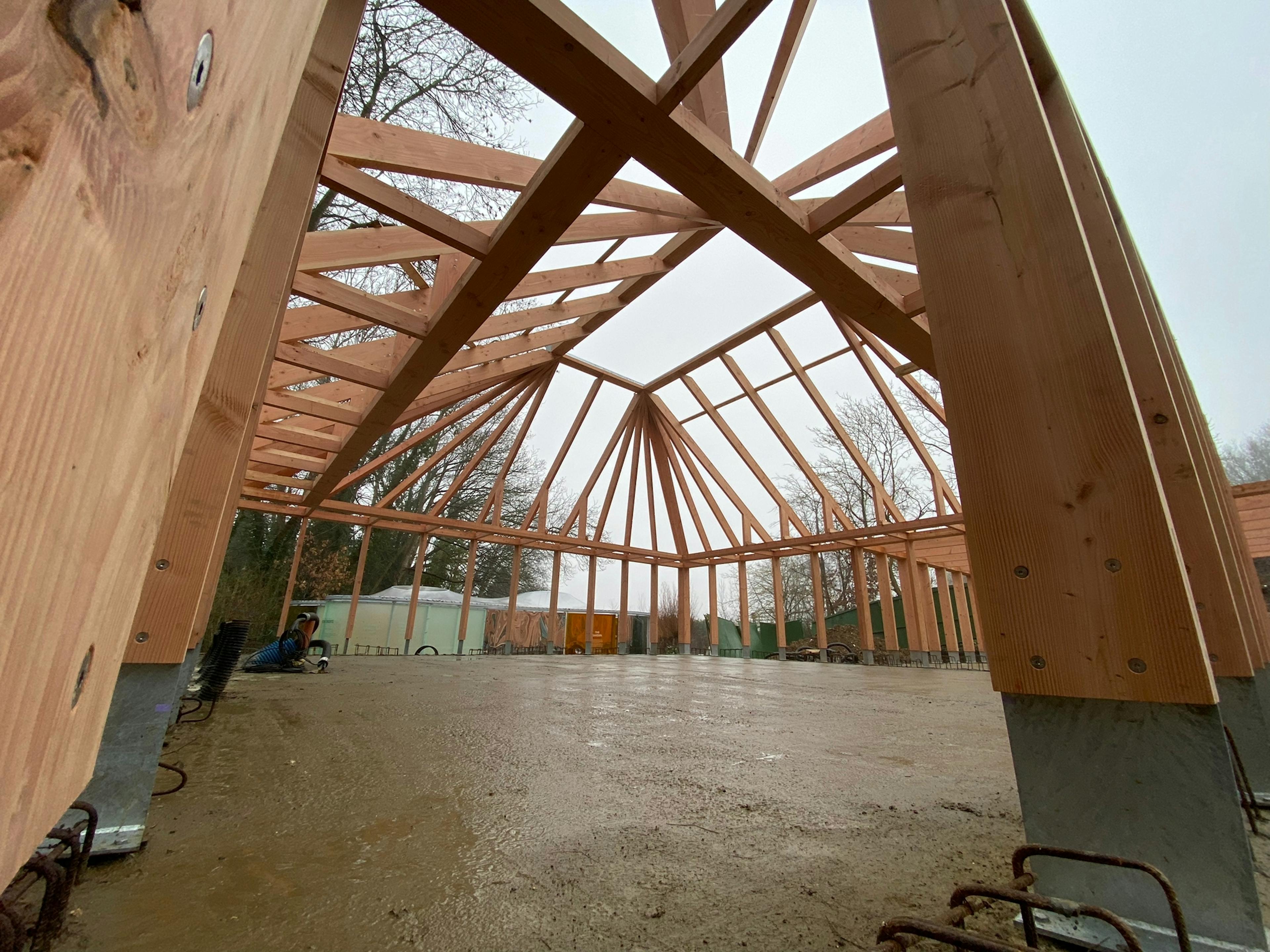 A larch glulam frame of a pyramidic building on a construction site during installation