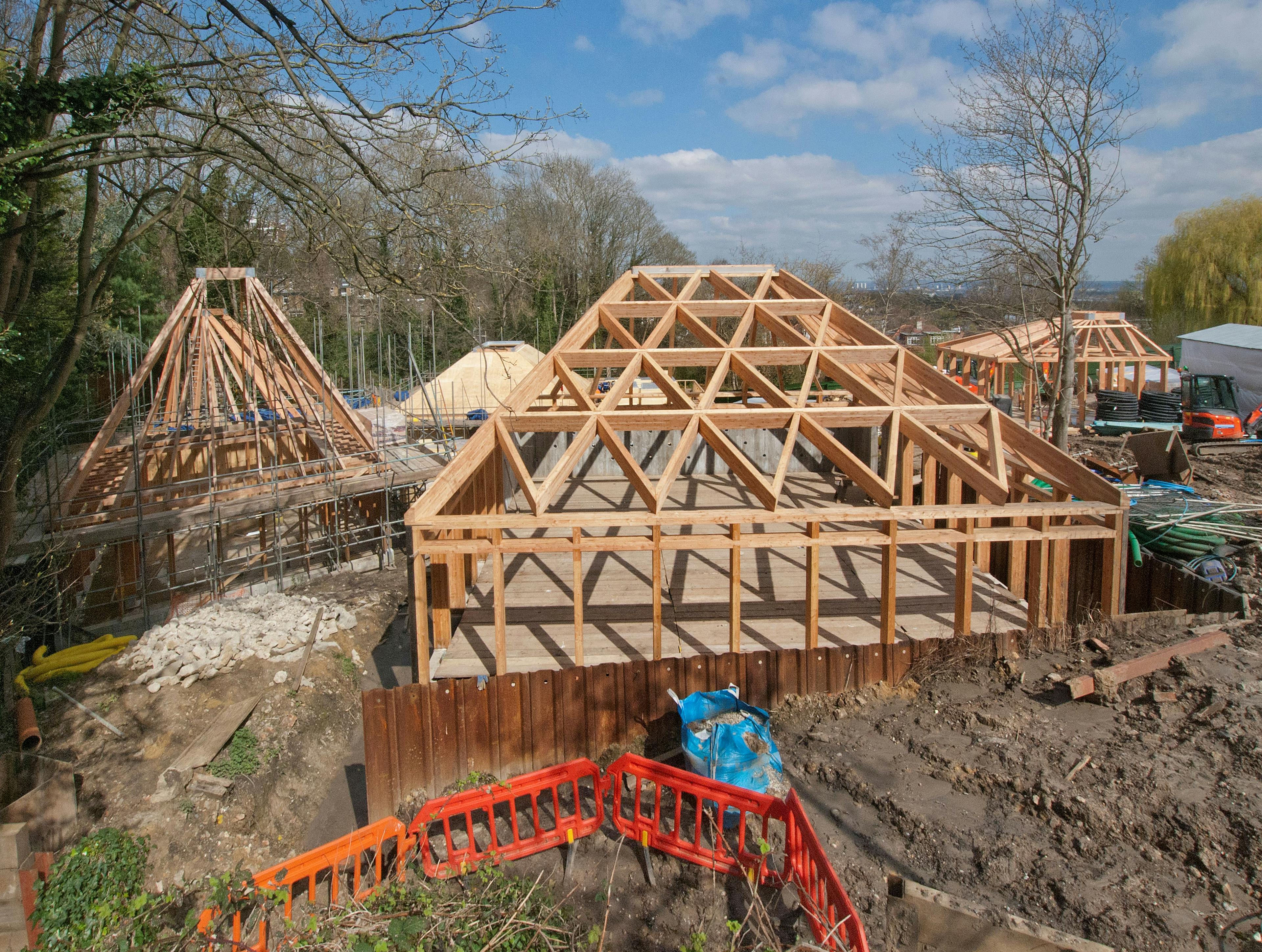Two timber framed buildings during installation on a construction site