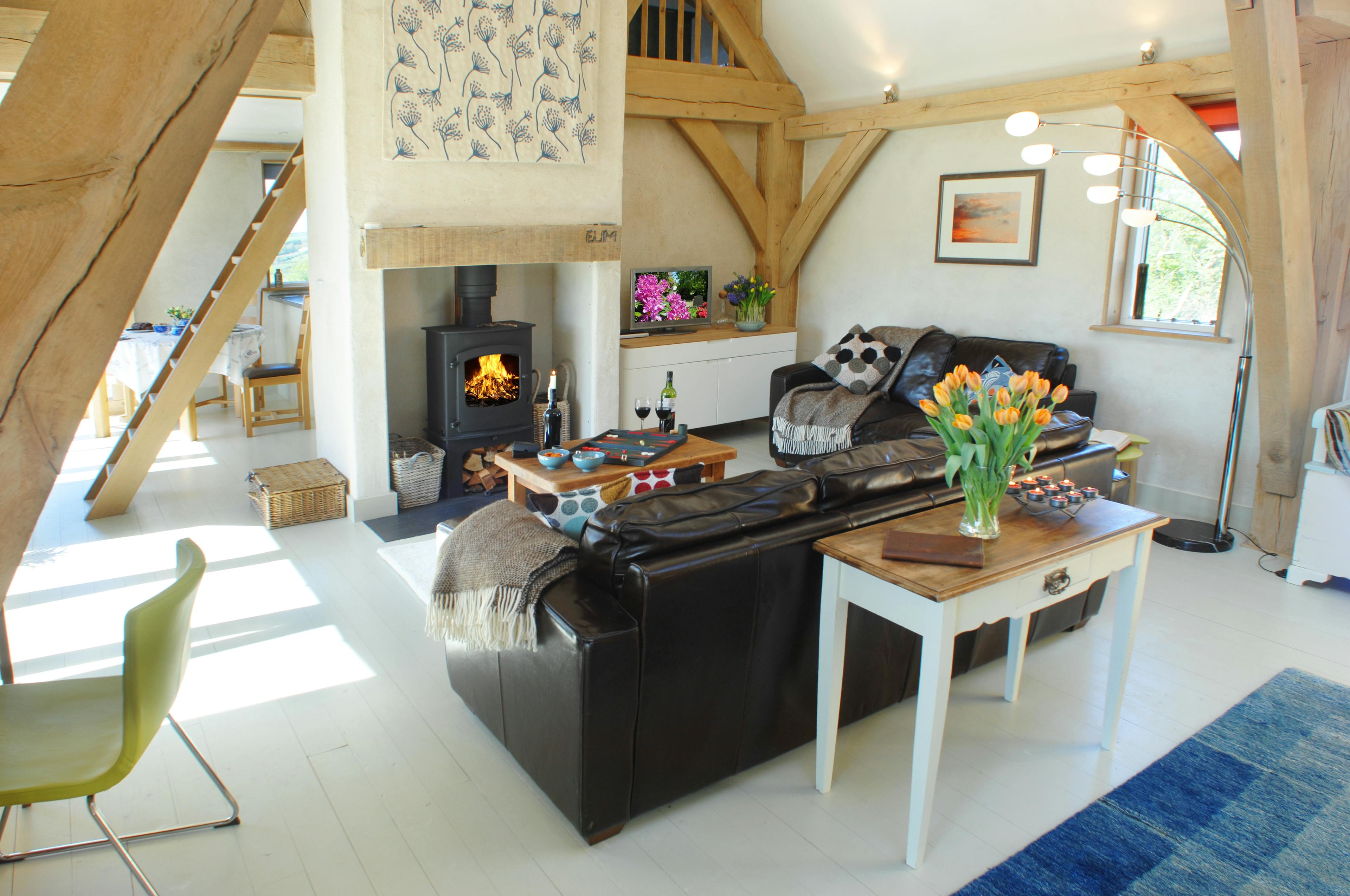 Completed interior of an oak-framed home in Cornwall, featuring a cozy lounge with natural wood accents and a bright, inviting atmosphere