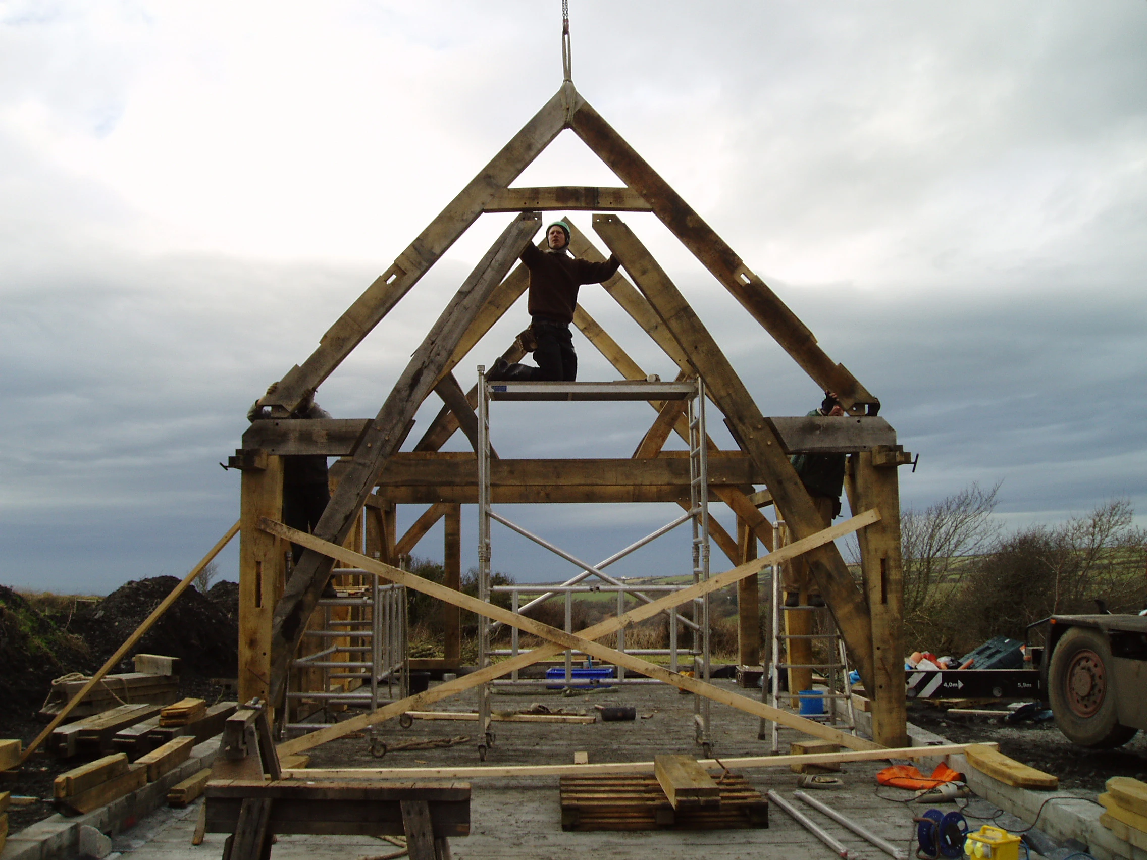 On-site assembly of an oak-framed sling brace truss, showcasing traditional craftsmanship and structural precision