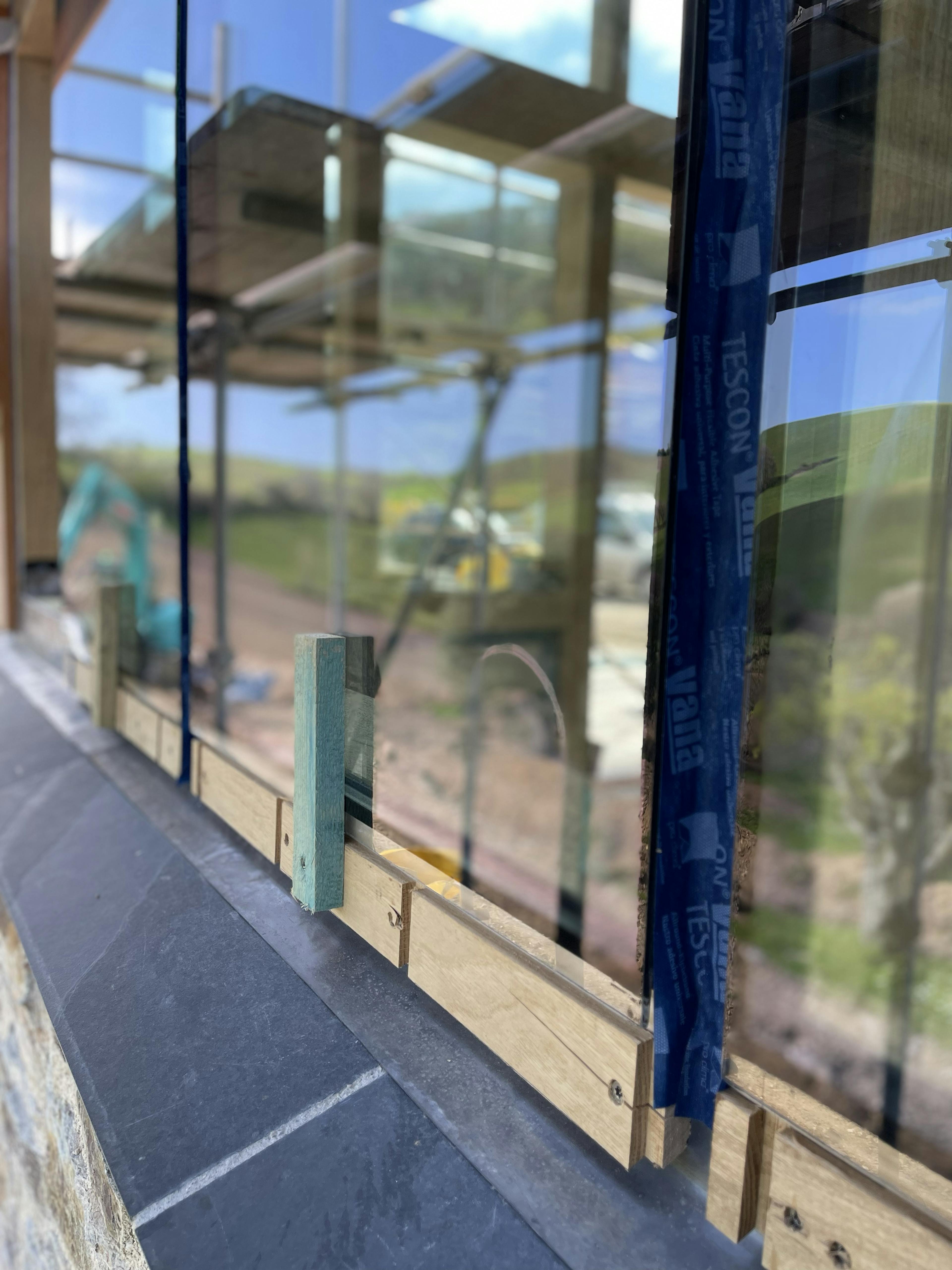 The glazing for an oak framed garden room, entrance and corridor extension being installed 