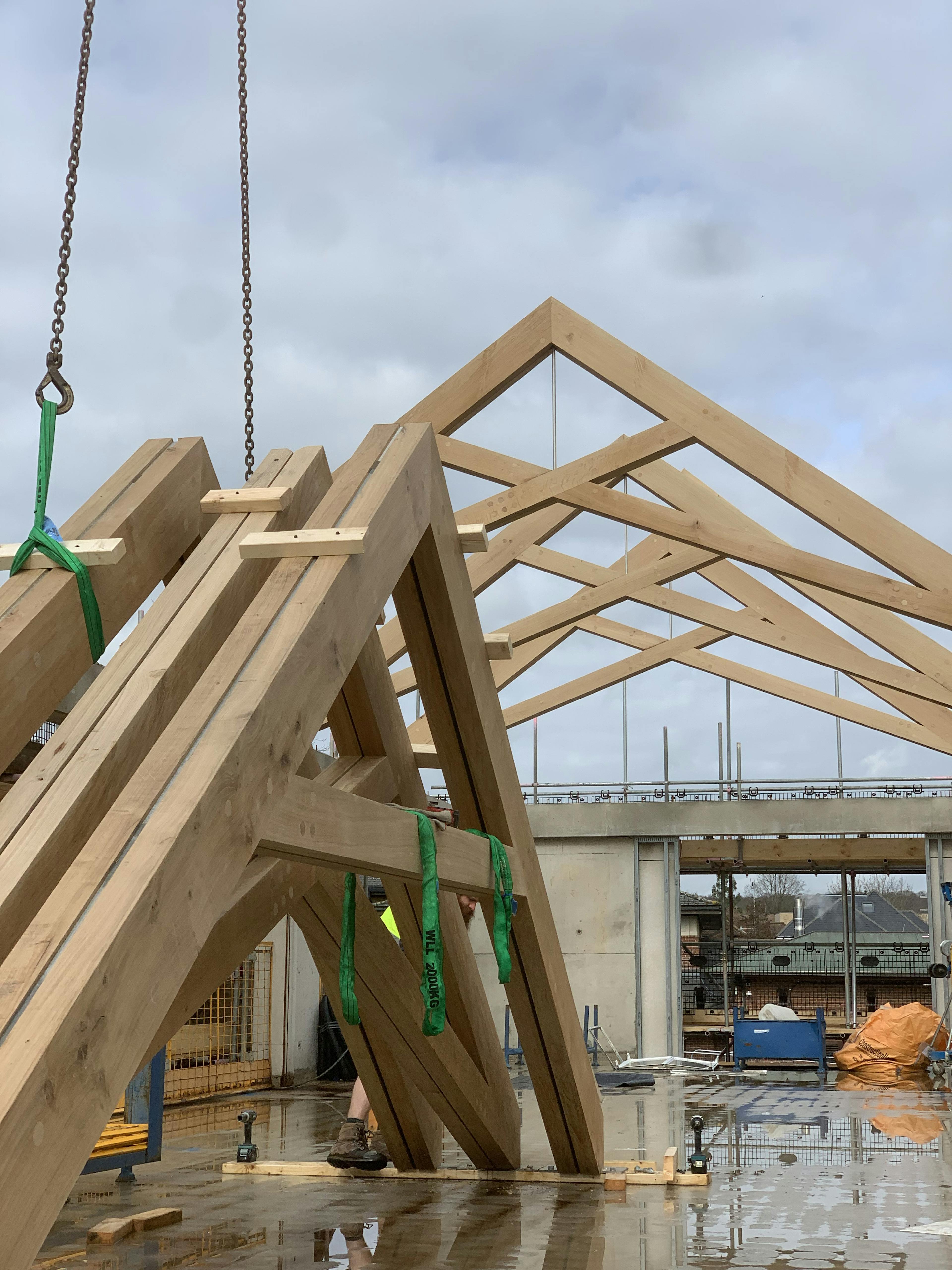 Air dried oak trusses for a roof in a school building, ready to be installed