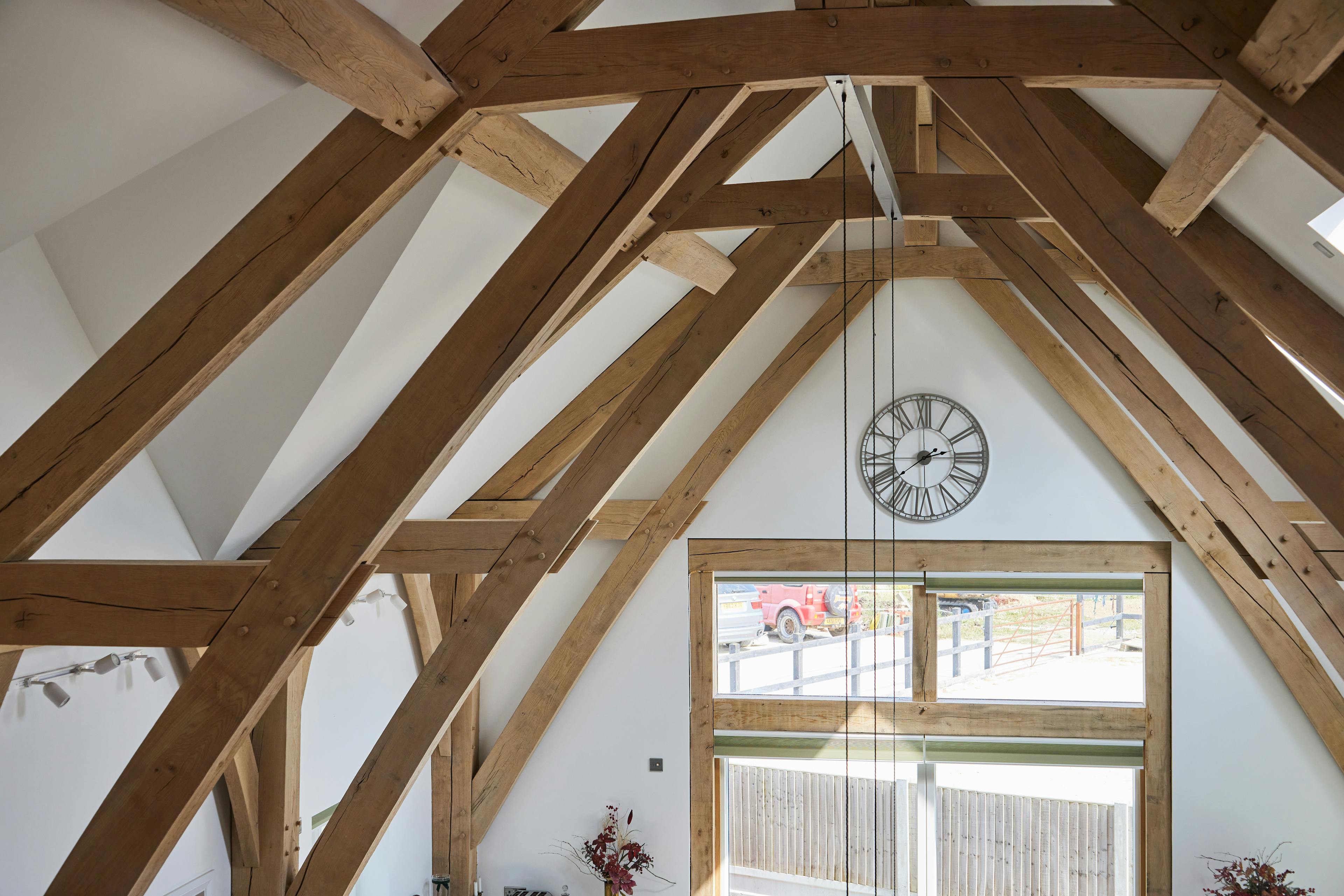An oak framed home with a double height vaulted ceiling.