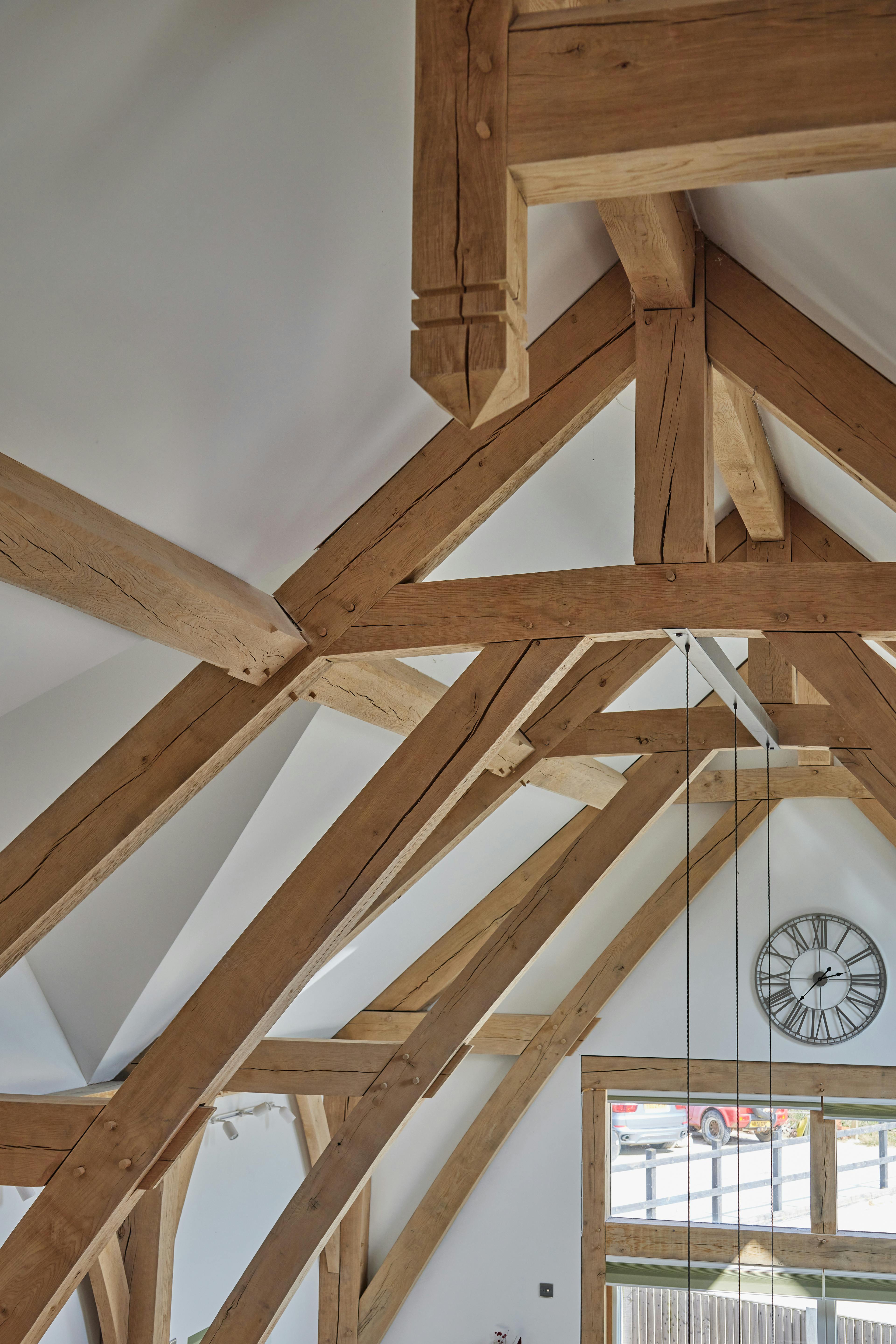 An oak framed home with a double height vaulted ceiling.