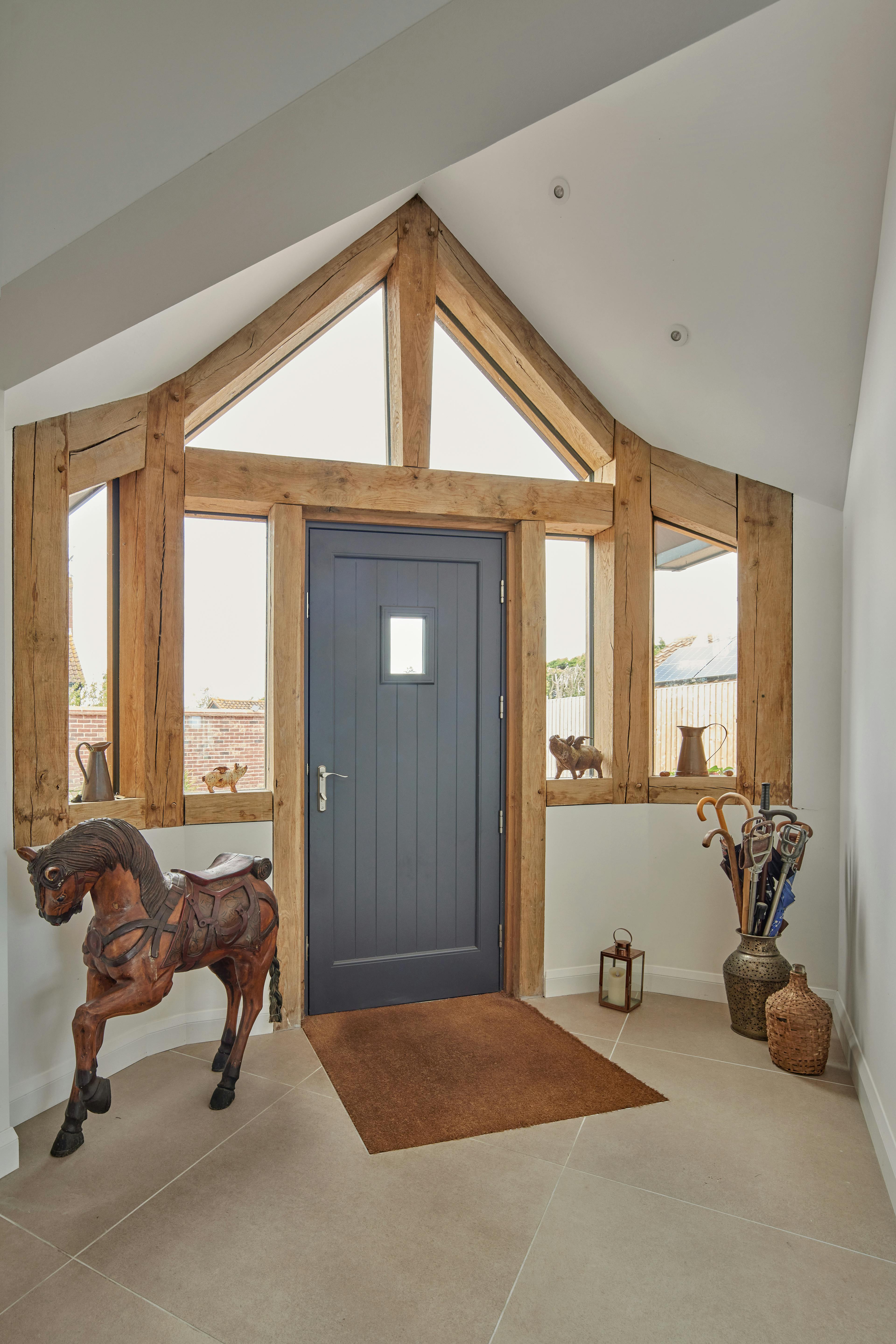 A an oak framed entrance area with a blue front door in an oak framed home