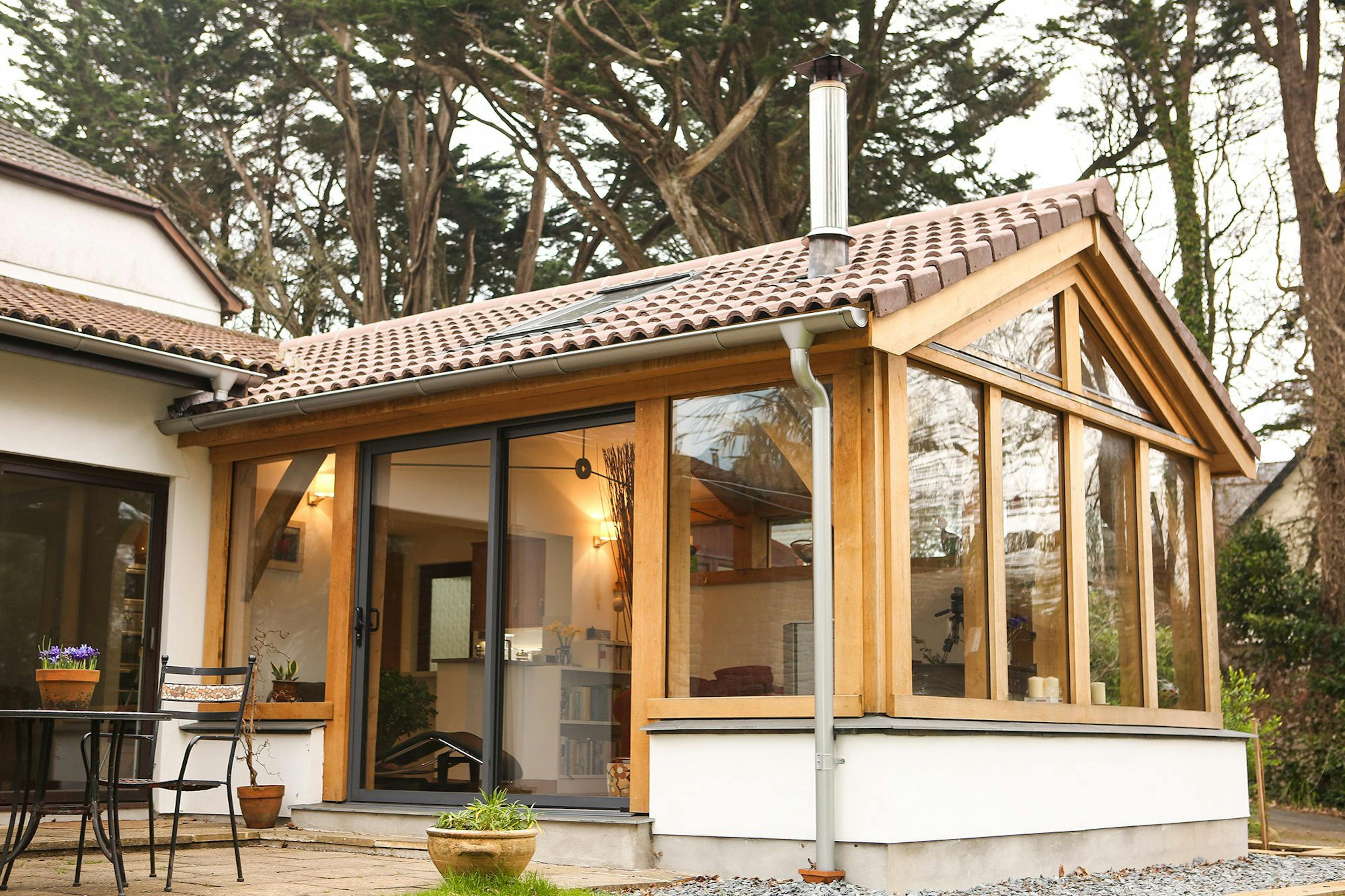 Oak-framed extension in Cornwall with expansive glazing, creating a bright and open living room that connects seamlessly to the outdoor space