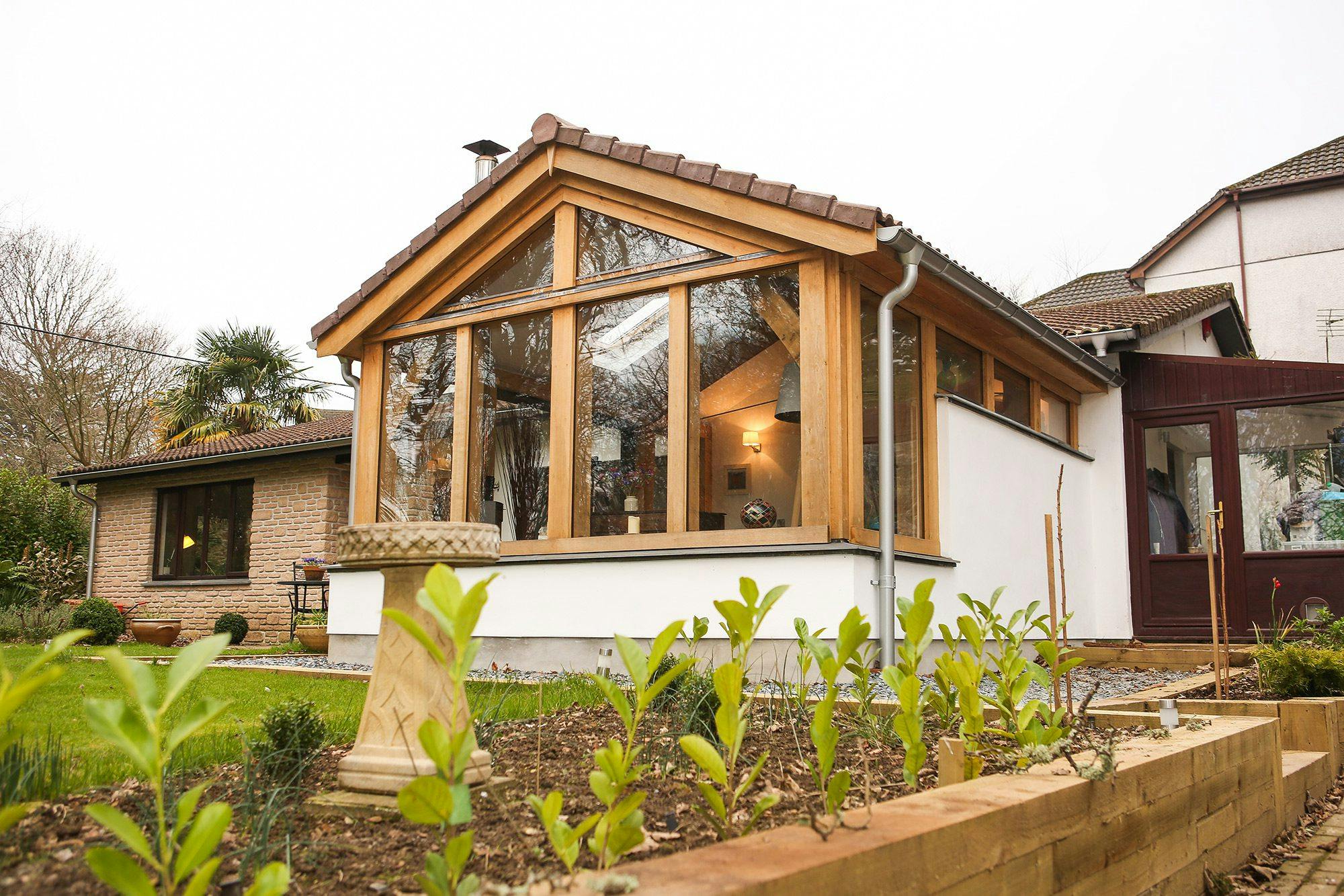 Oak-framed extension in Cornwall featuring a spacious living room with large glass doors, seamlessly connecting the interior to the outdoor space