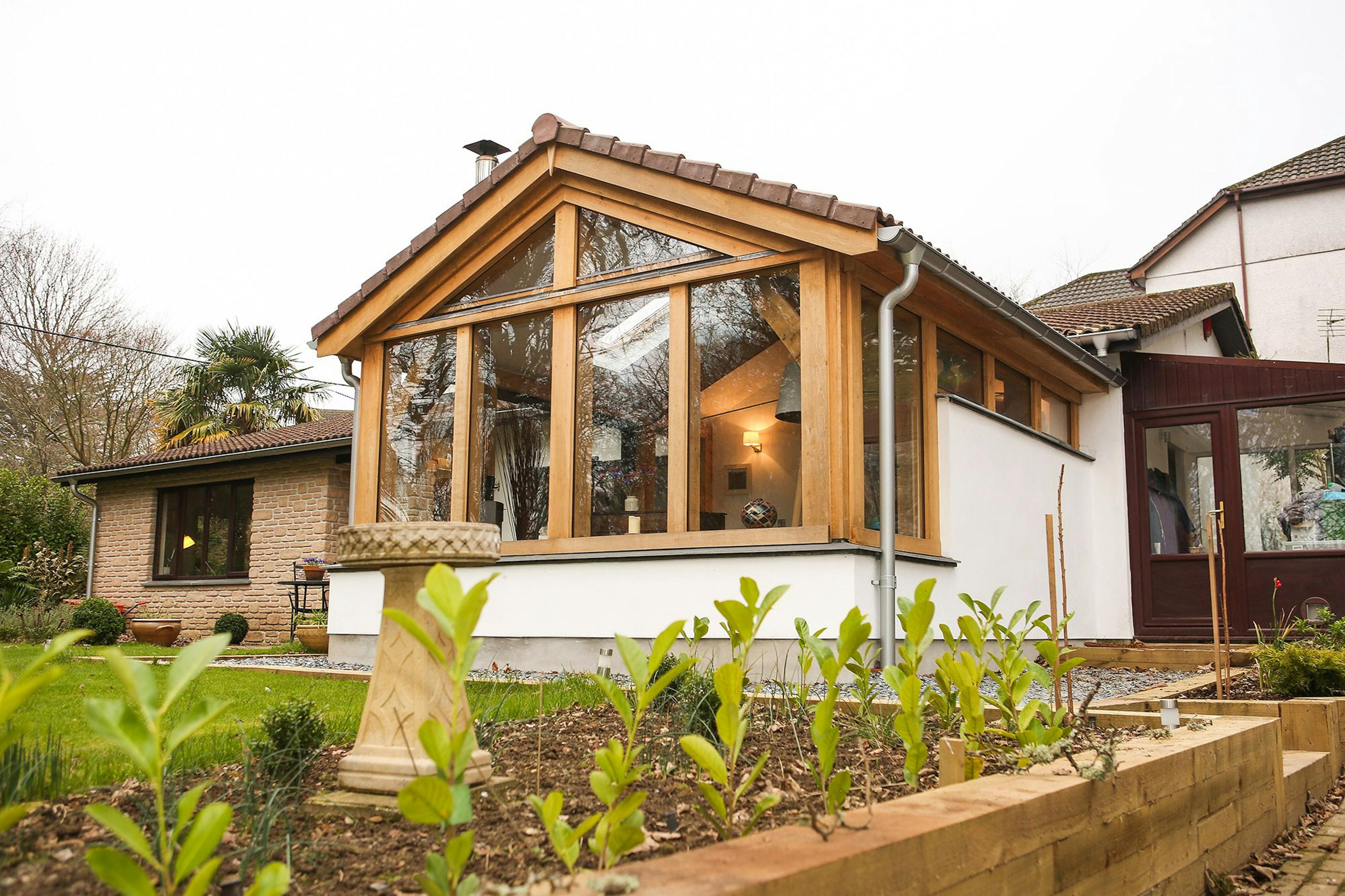 Oak-framed extension in Cornwall featuring a spacious living room with large glass doors, seamlessly connecting the interior to the outdoor space