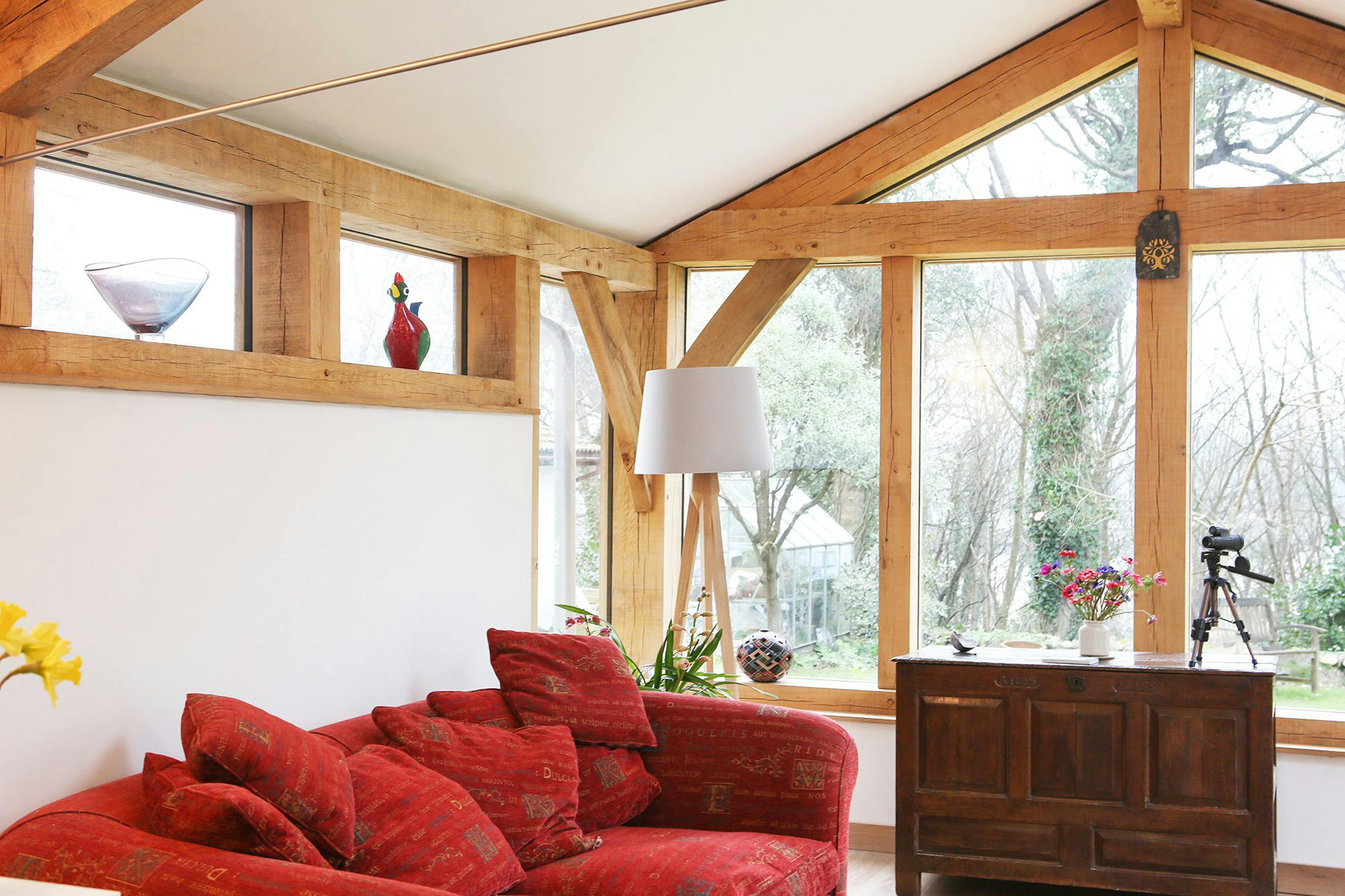 Oak-framed extension with expansive glazing, creating a bright and airy living room with seamless indoor-outdoor flow