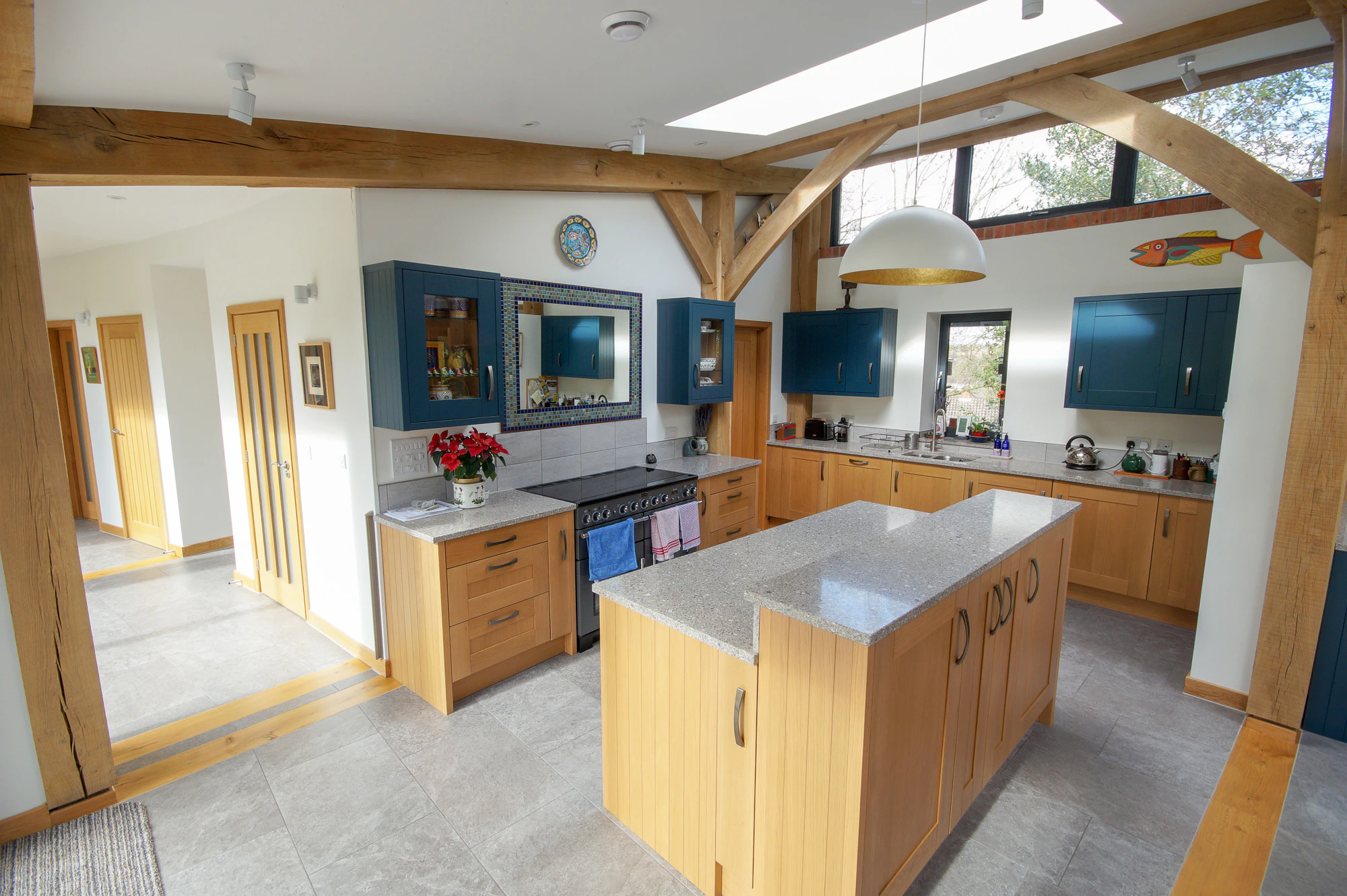 An open plan kitchen in a curved oak frame home