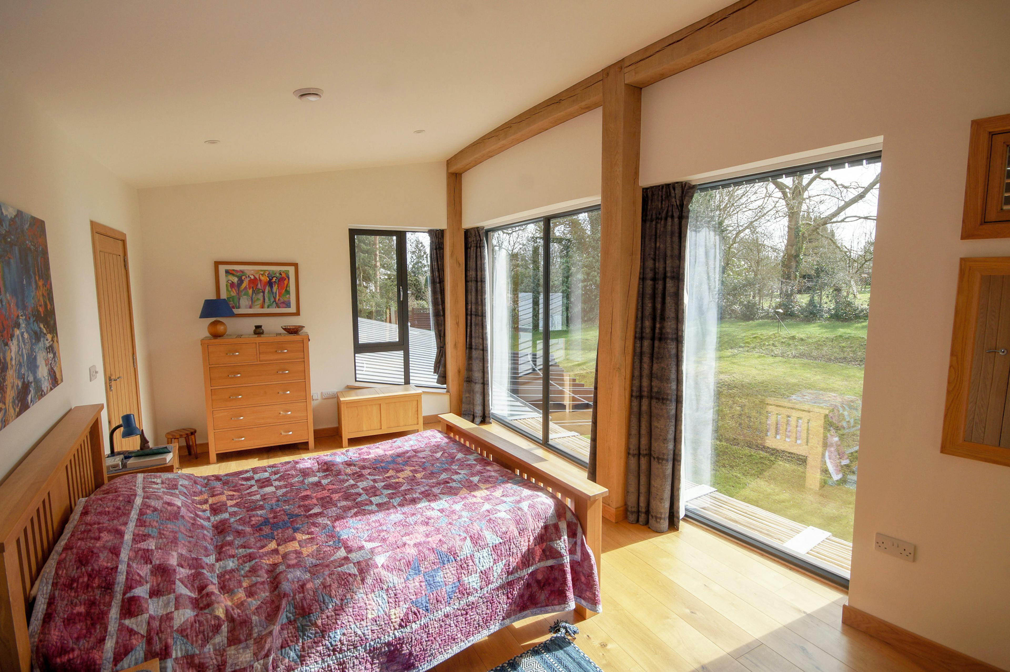 An bedroom in a curved oak frame home
