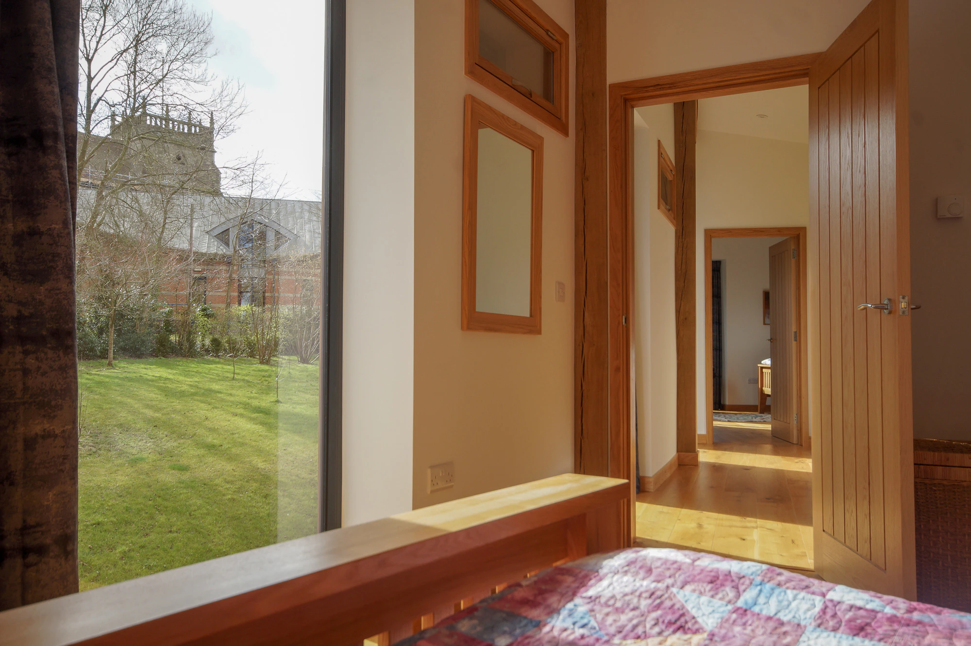 An bedroom in a curved oak frame home