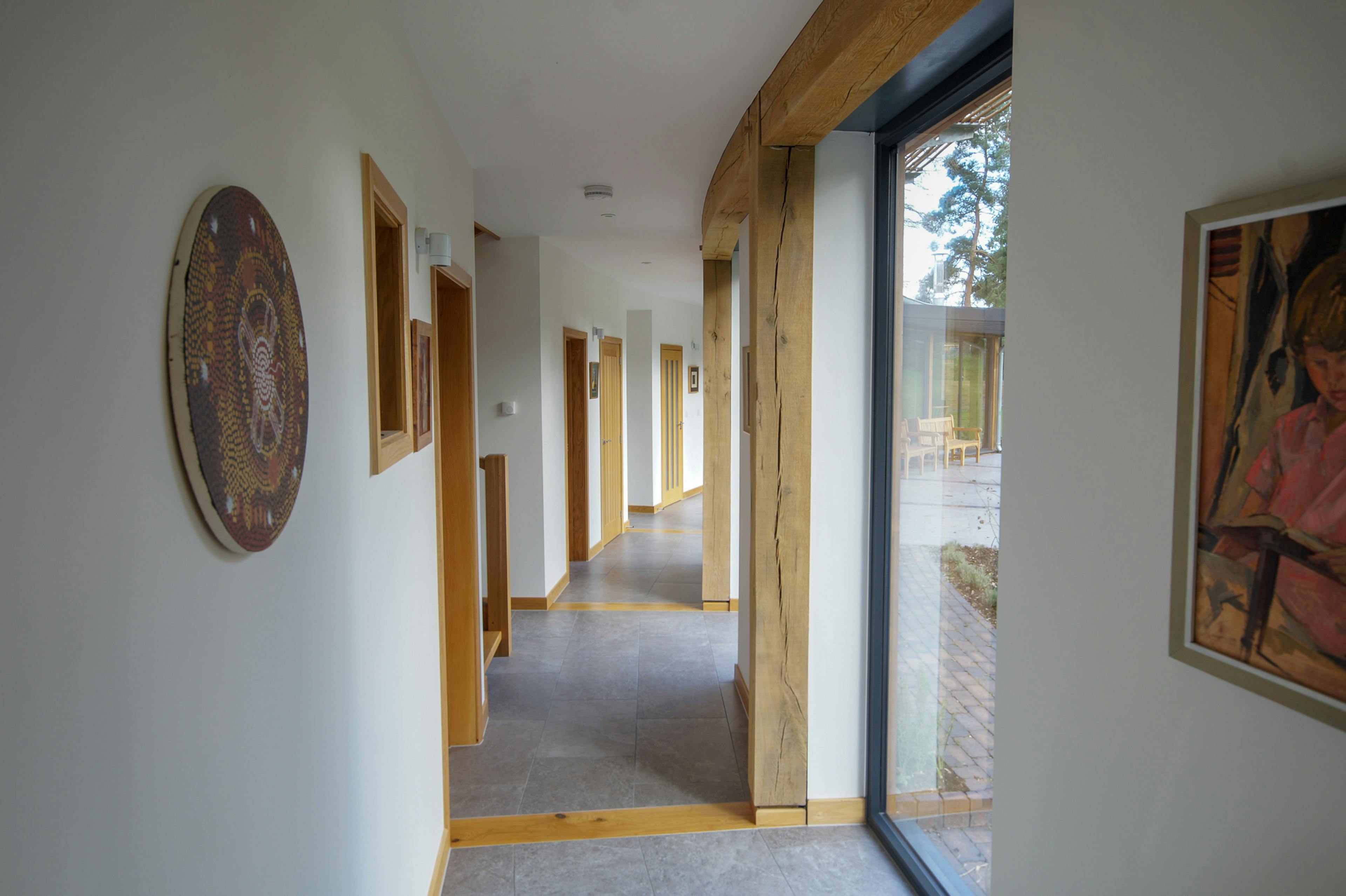 A corridor in a curved oak frame home