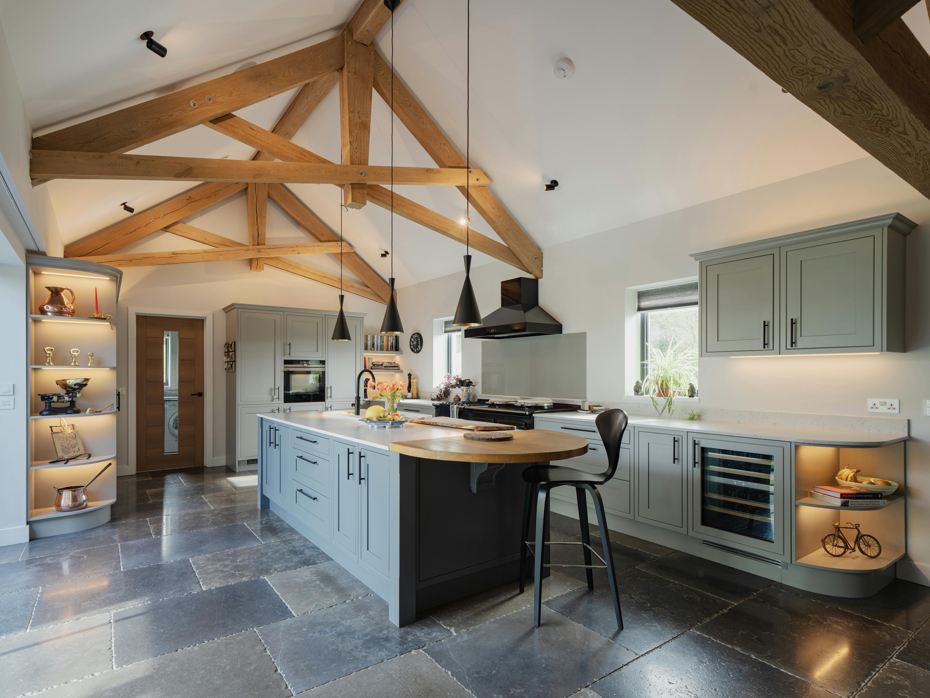 A modern oak framed kitchen with a central island and scissor truss