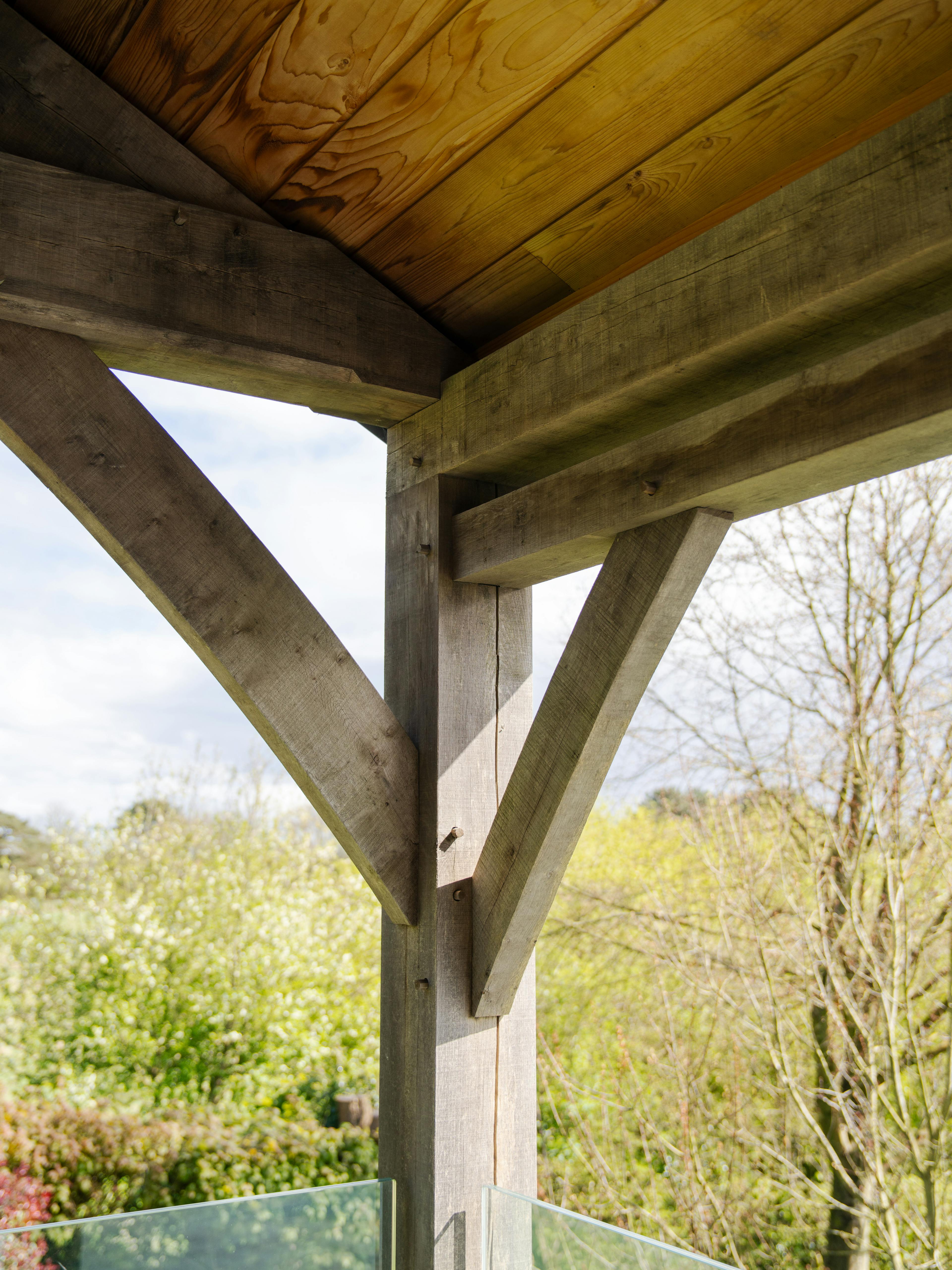 An oak framed post of a covered outdoor eating area