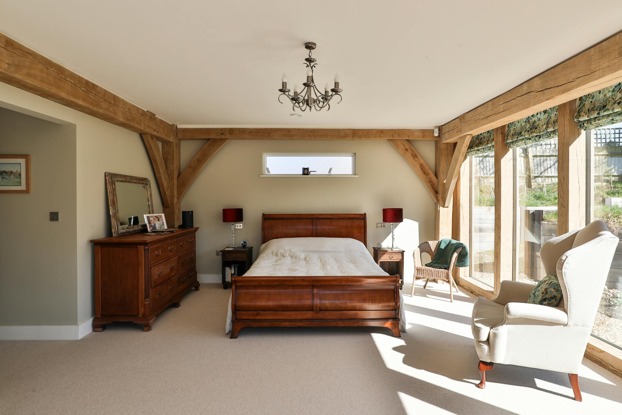 An oak framed bedroom with large direct glazed windows