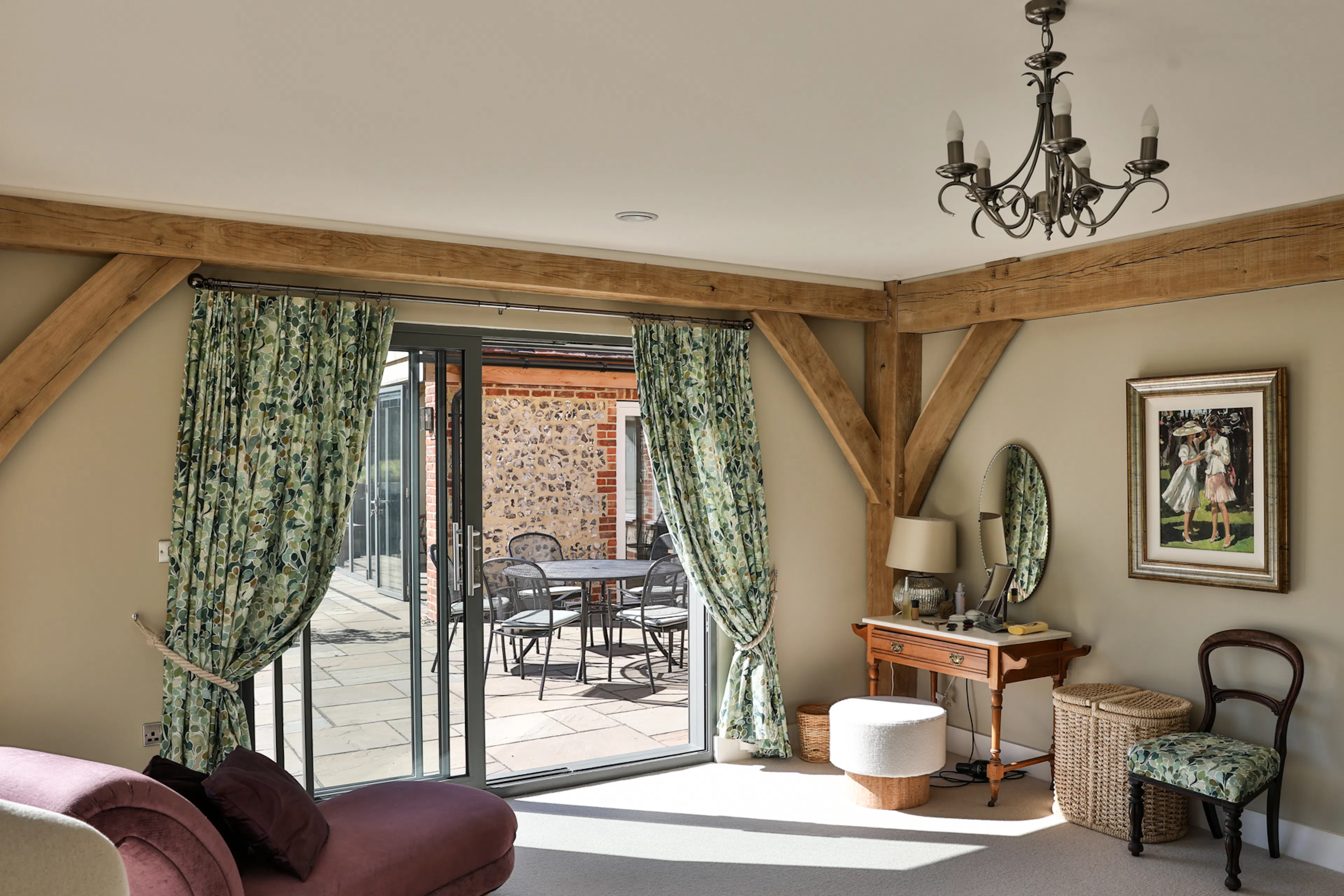 An oak framed bedroom with sliding doors to a sunny patio