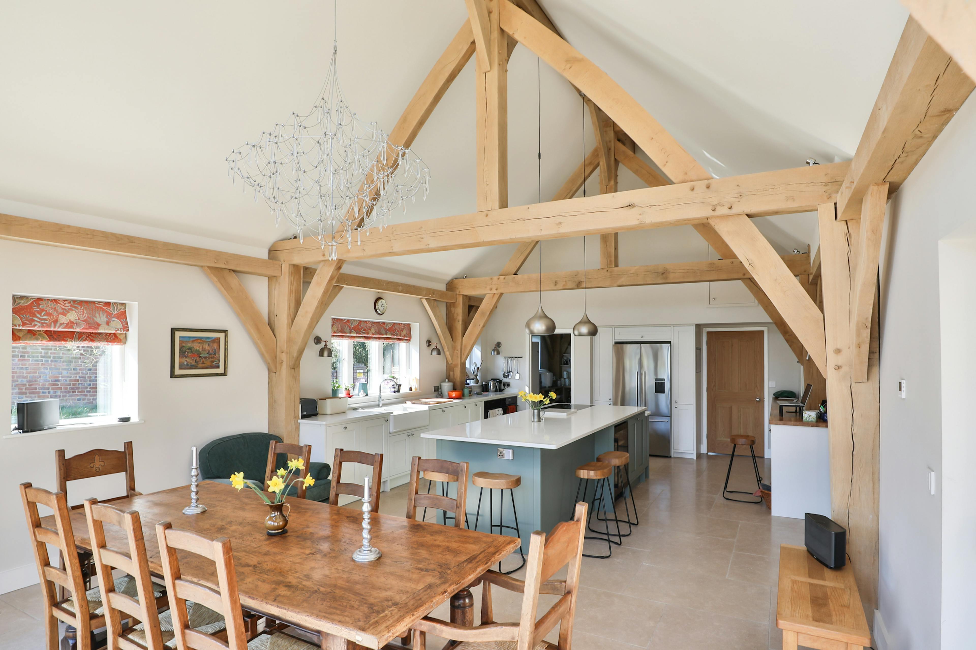 An open plan vaulted oak framed kitchen diner with an island and breakfast bar