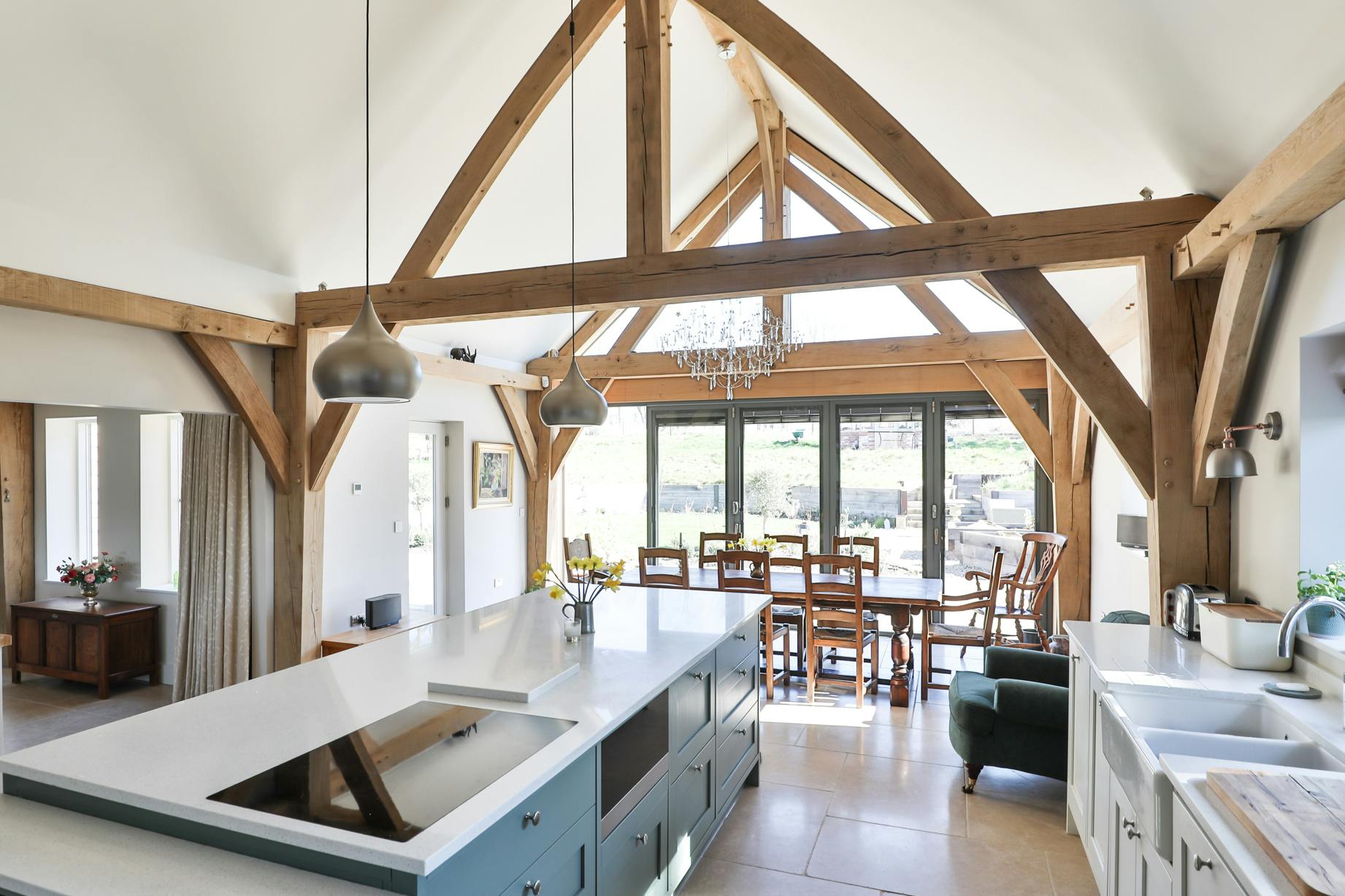 An open plan vaulted oak framed kitchen diner with an island