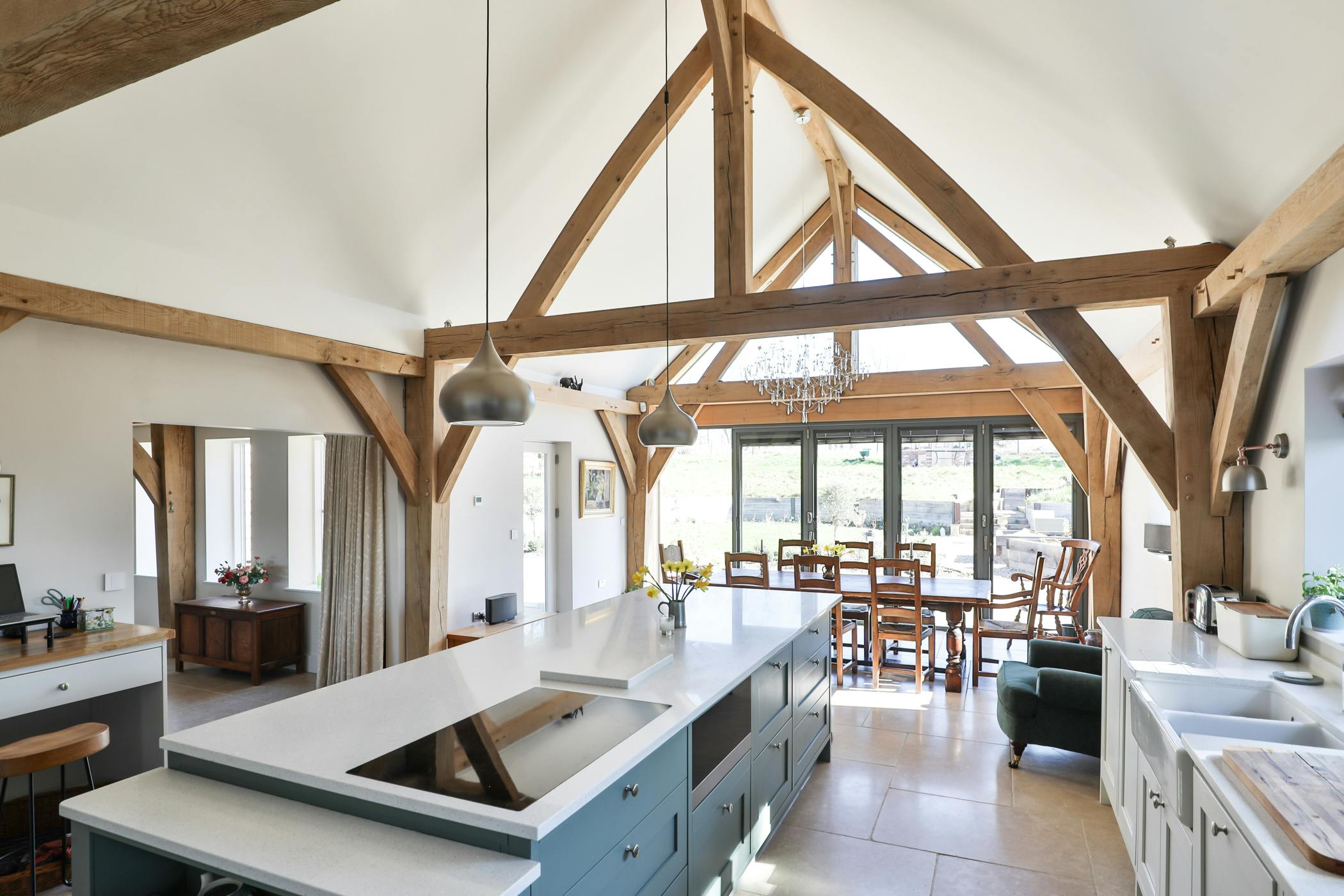 An open plan vaulted oak framed kitchen diner with an island