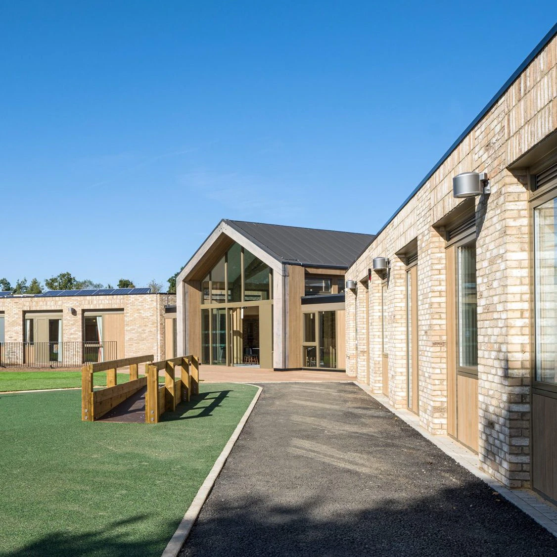 A single storey brick children's hospital with a large oak framed atrium