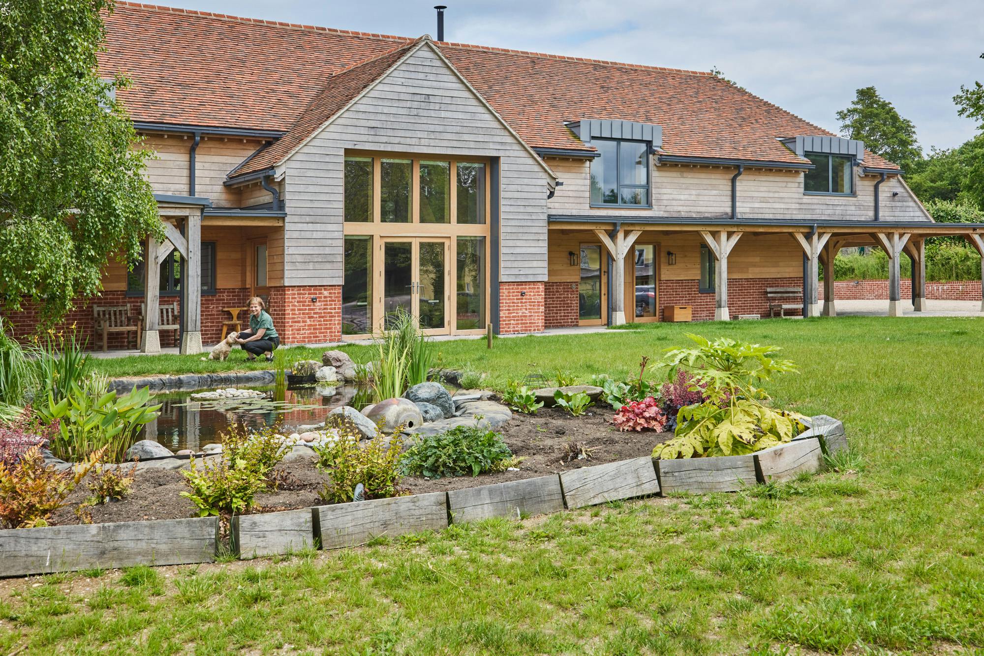 Exterior of large oak framed house with garden