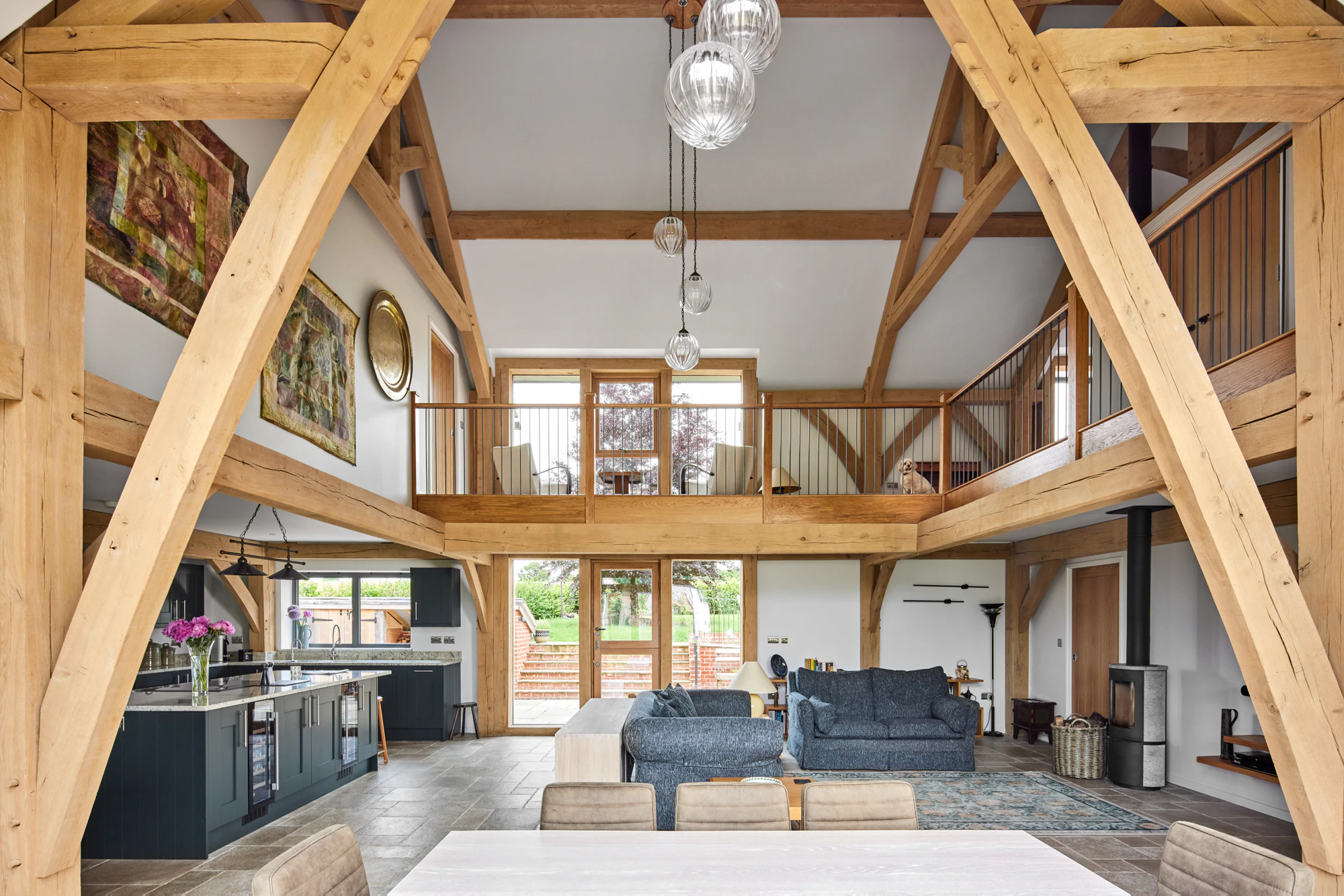 A large oak framed home with open plan living dining kitchen area and vaulted ceilings