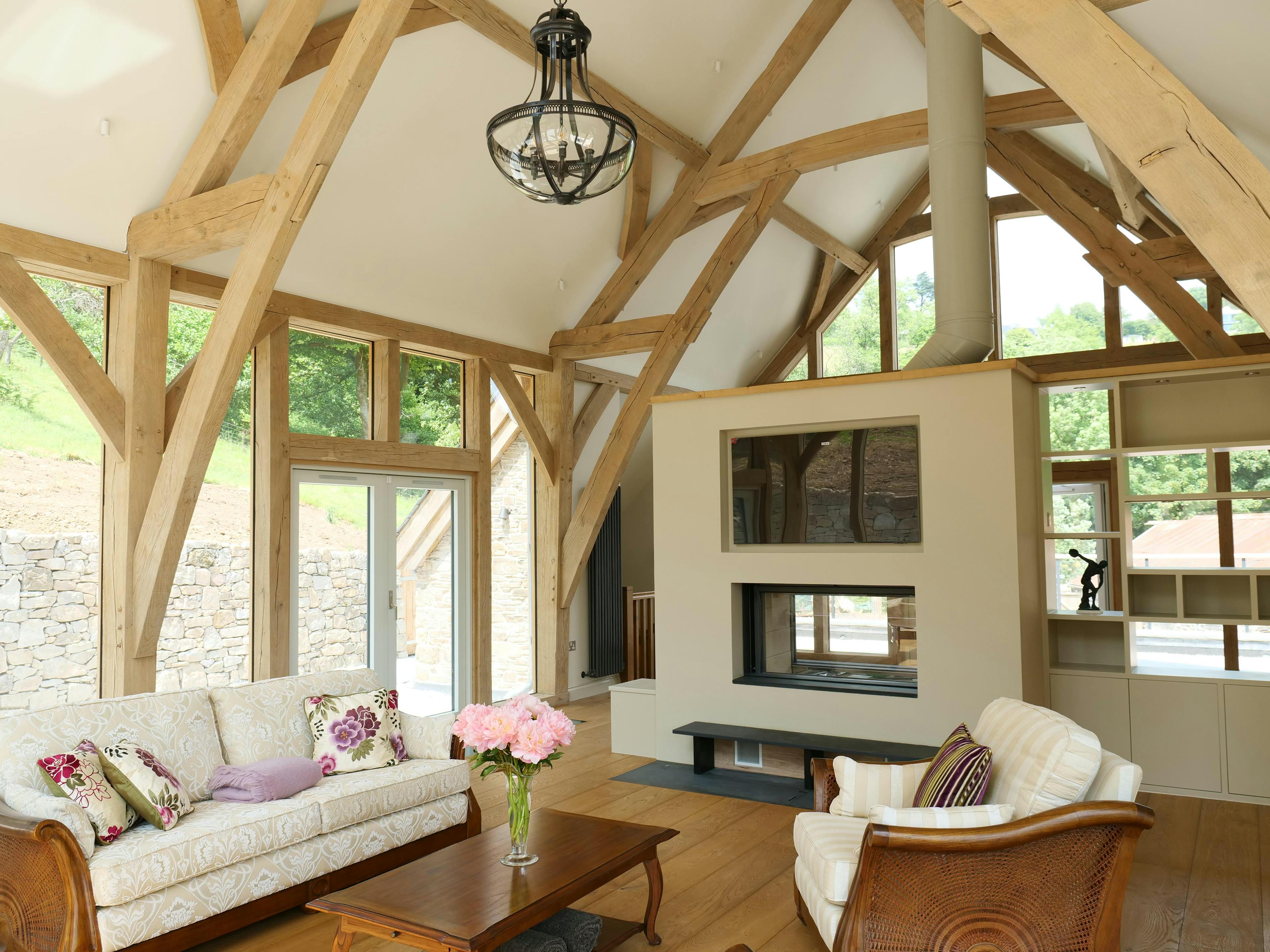 An oak framed extension with a sitting room and fire place