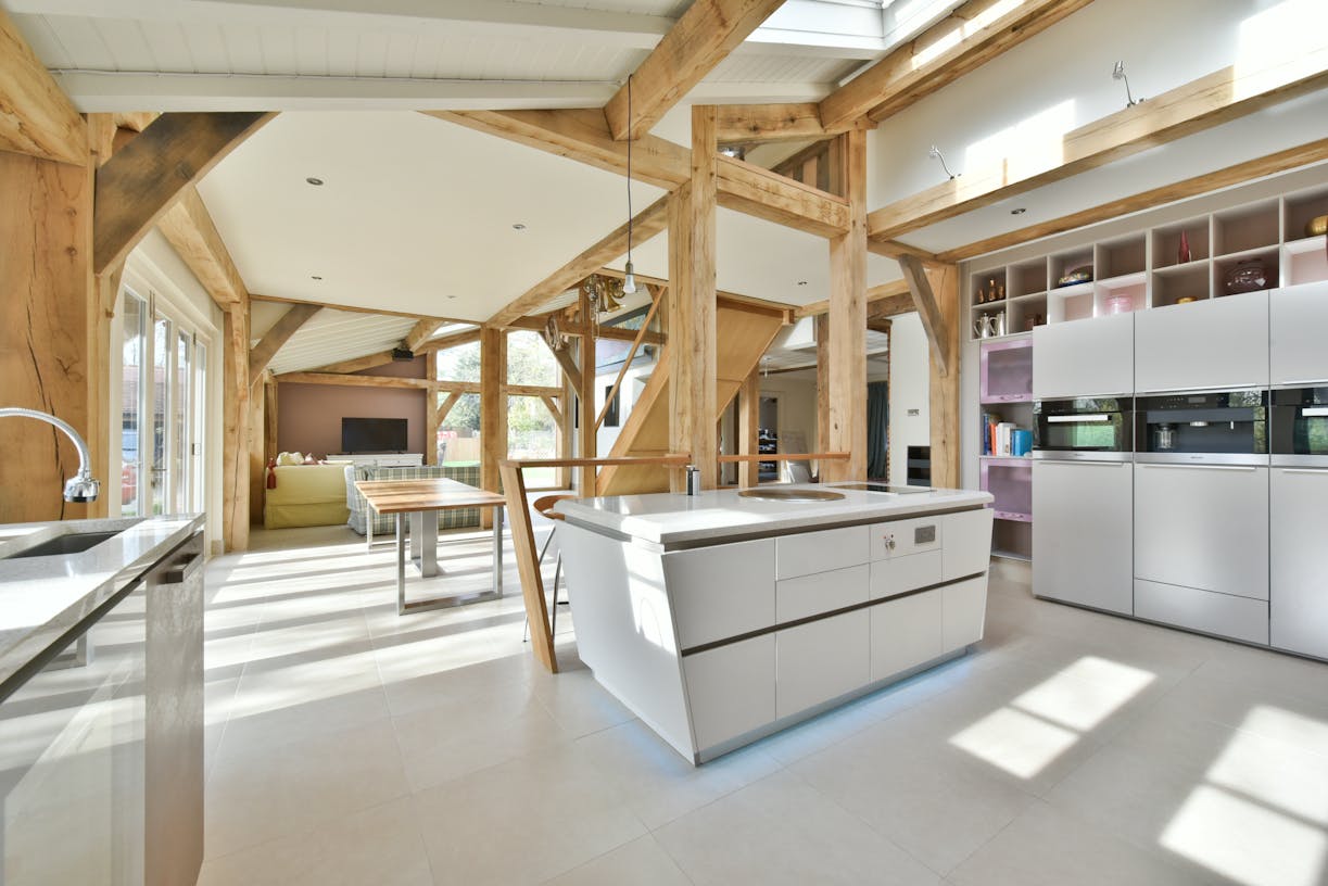 Sunlight floods into an oak framed extension with a modern kitchen