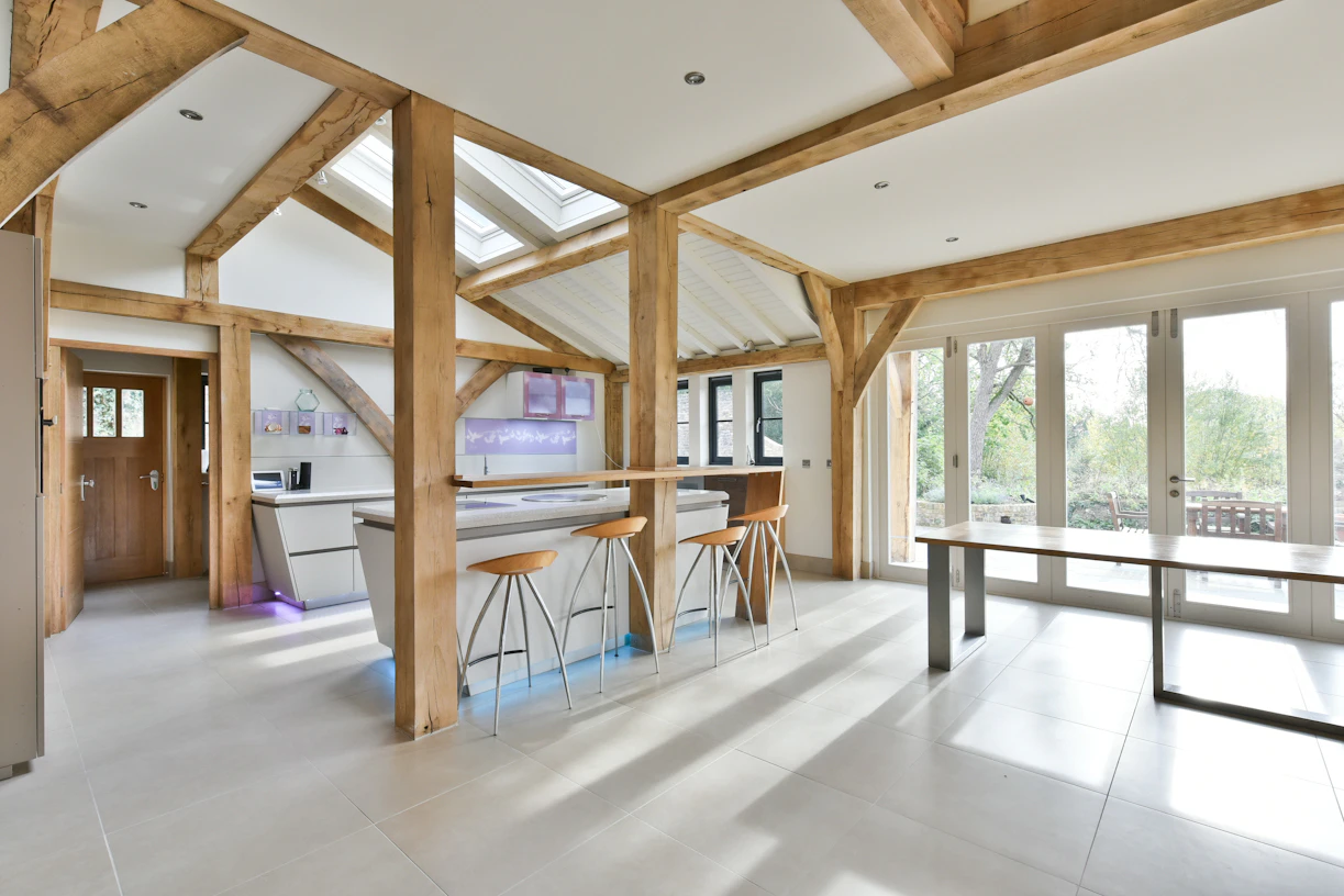 Sunlight floods into an oak framed extension with a modern kitchen and dining area