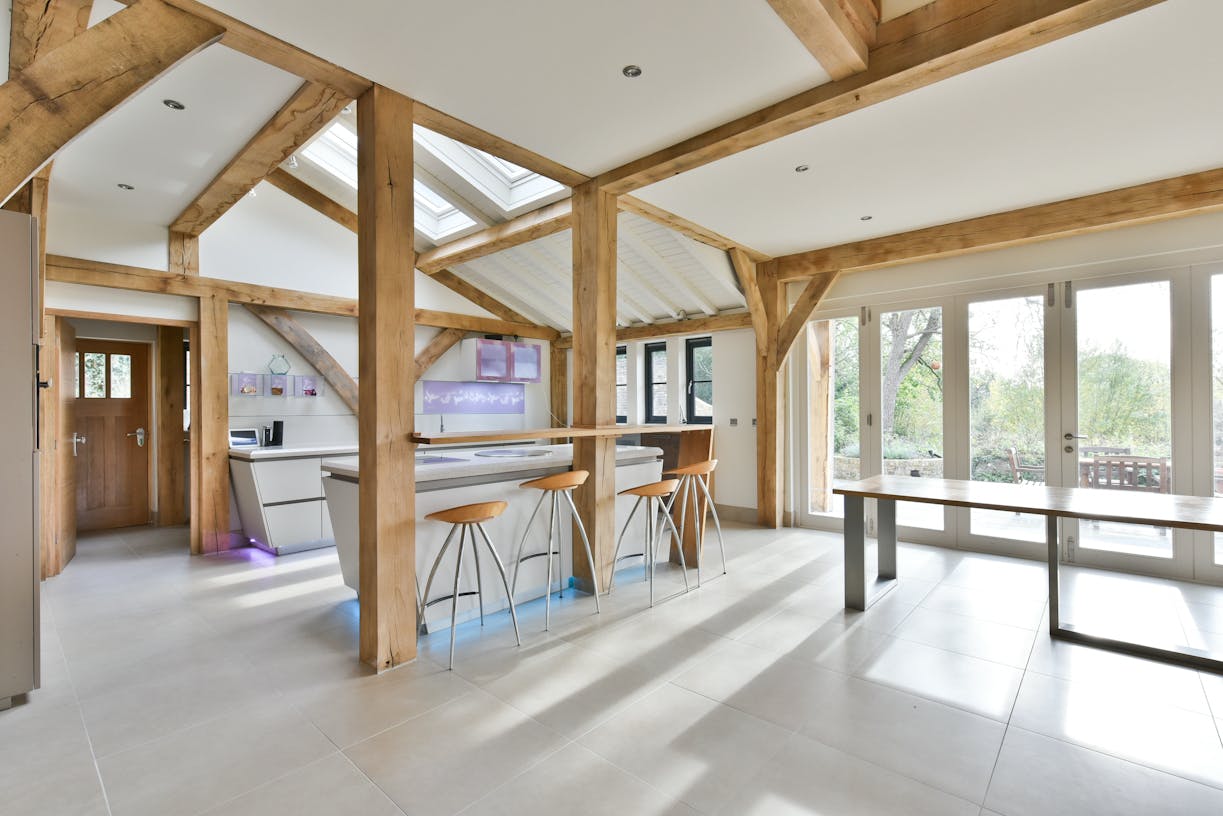 Sunlight floods into an oak framed extension with a modern kitchen and dining area